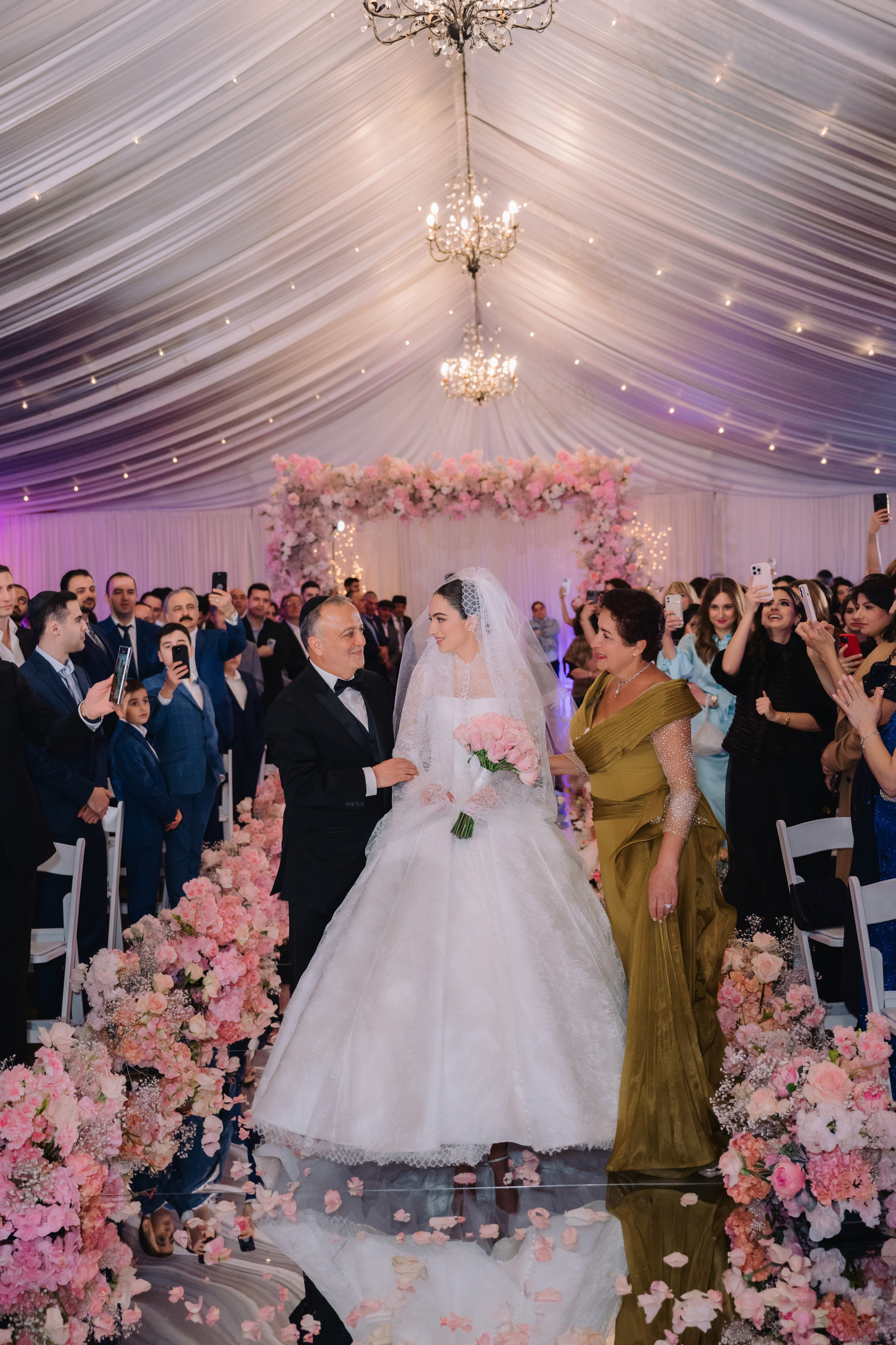 a bride and groom walk down the aisle at their wedding