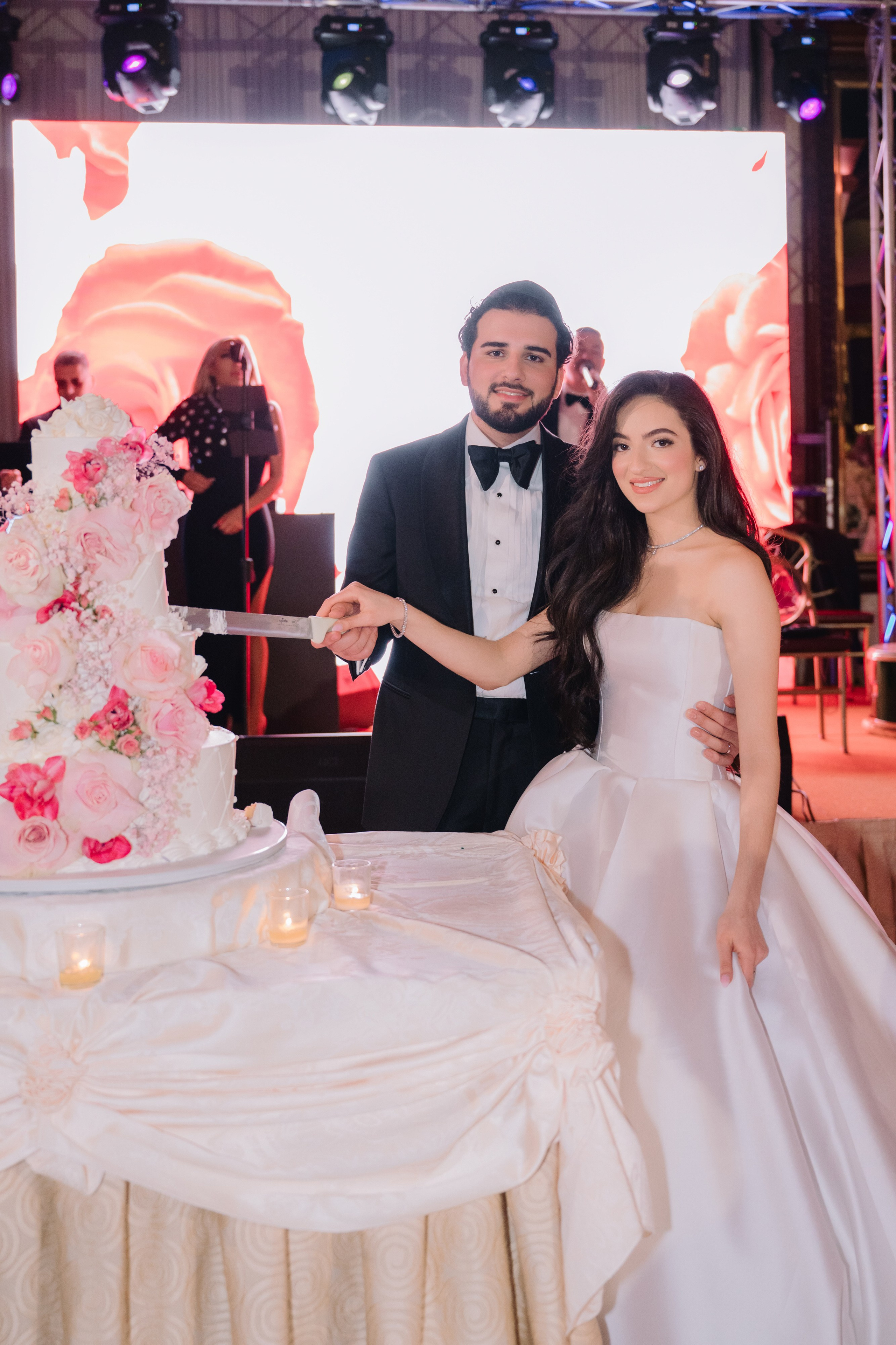 a man and woman cutting a wedding cake