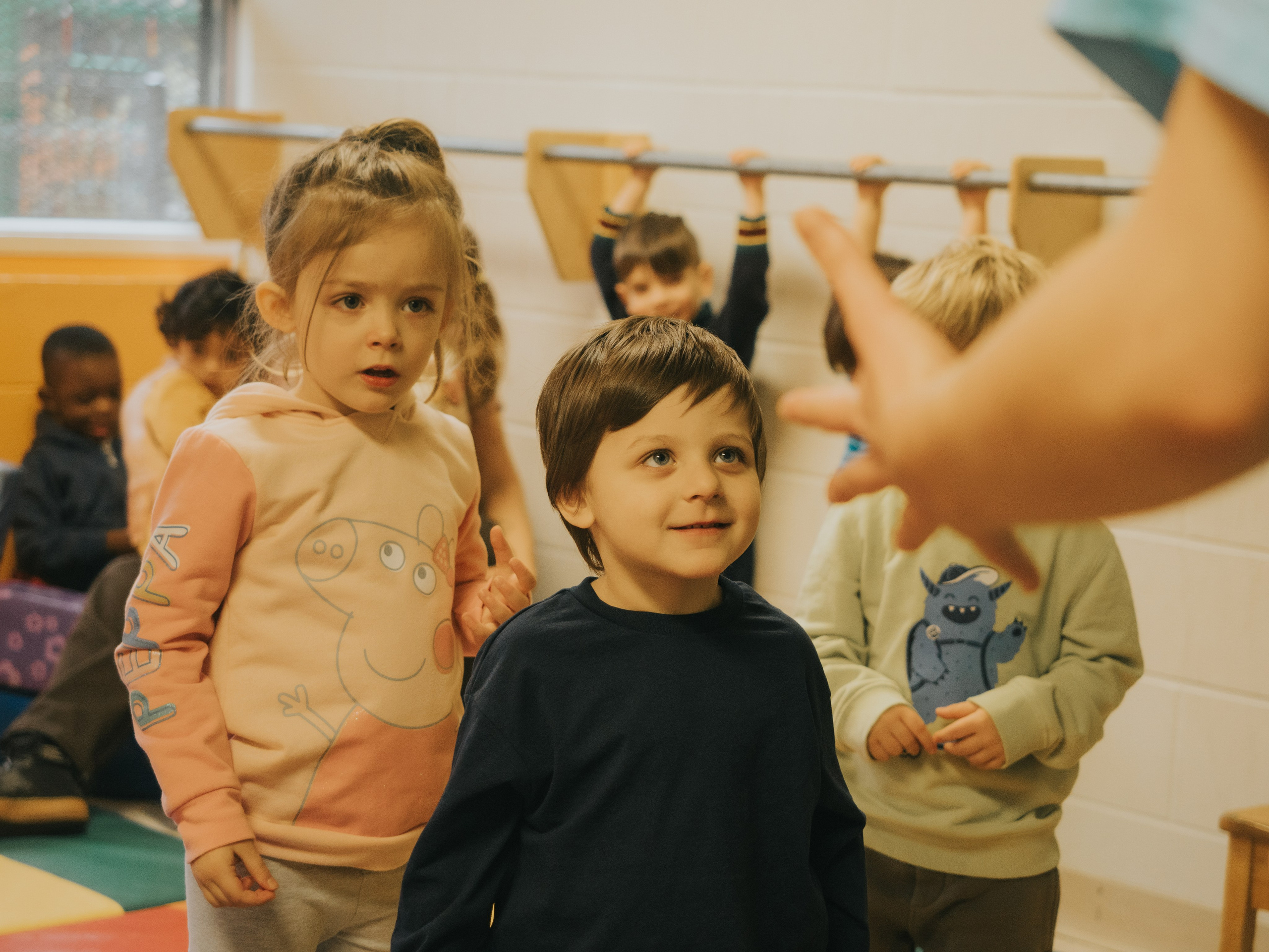 Children looking at their dance teacher.