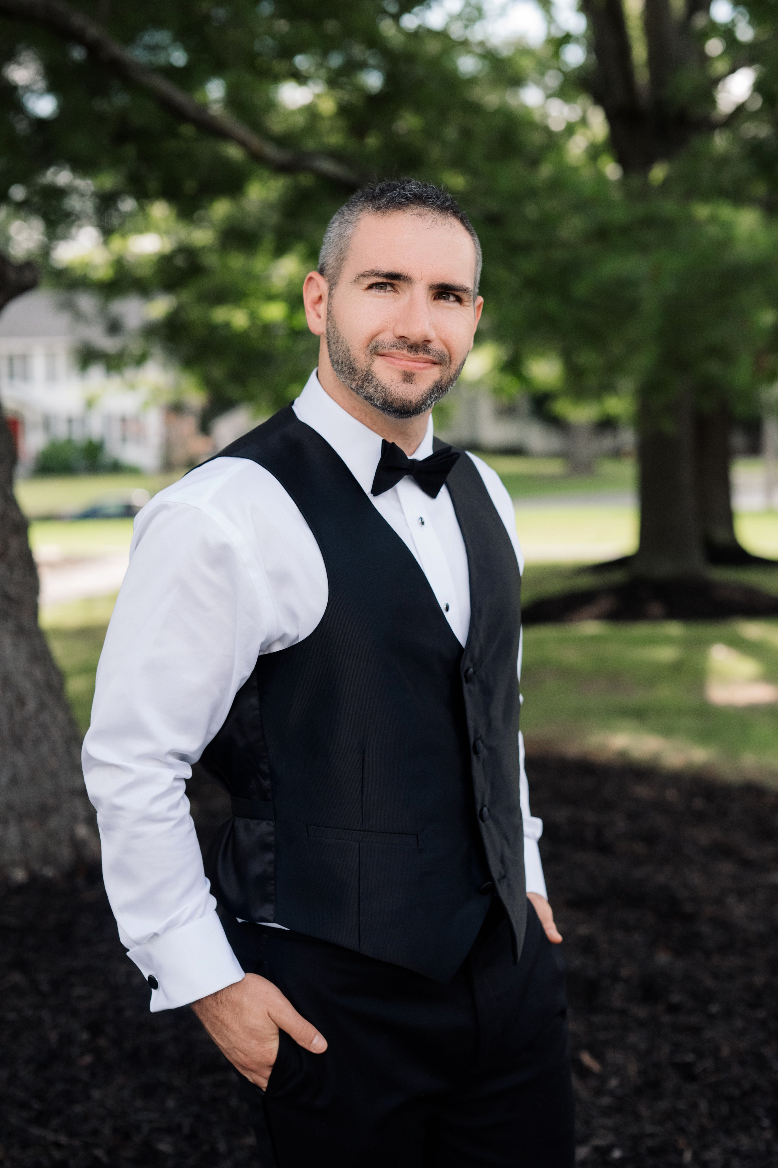 a man in a black vest and white shirt