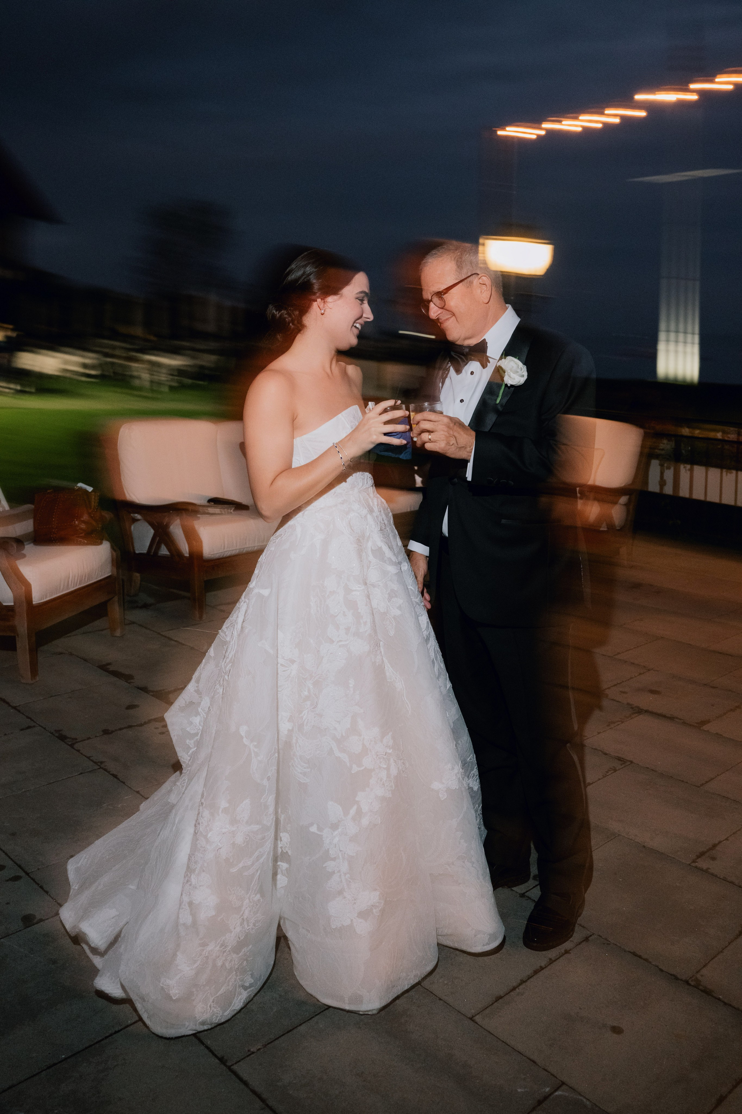 a bride and groom are dancing on the patio