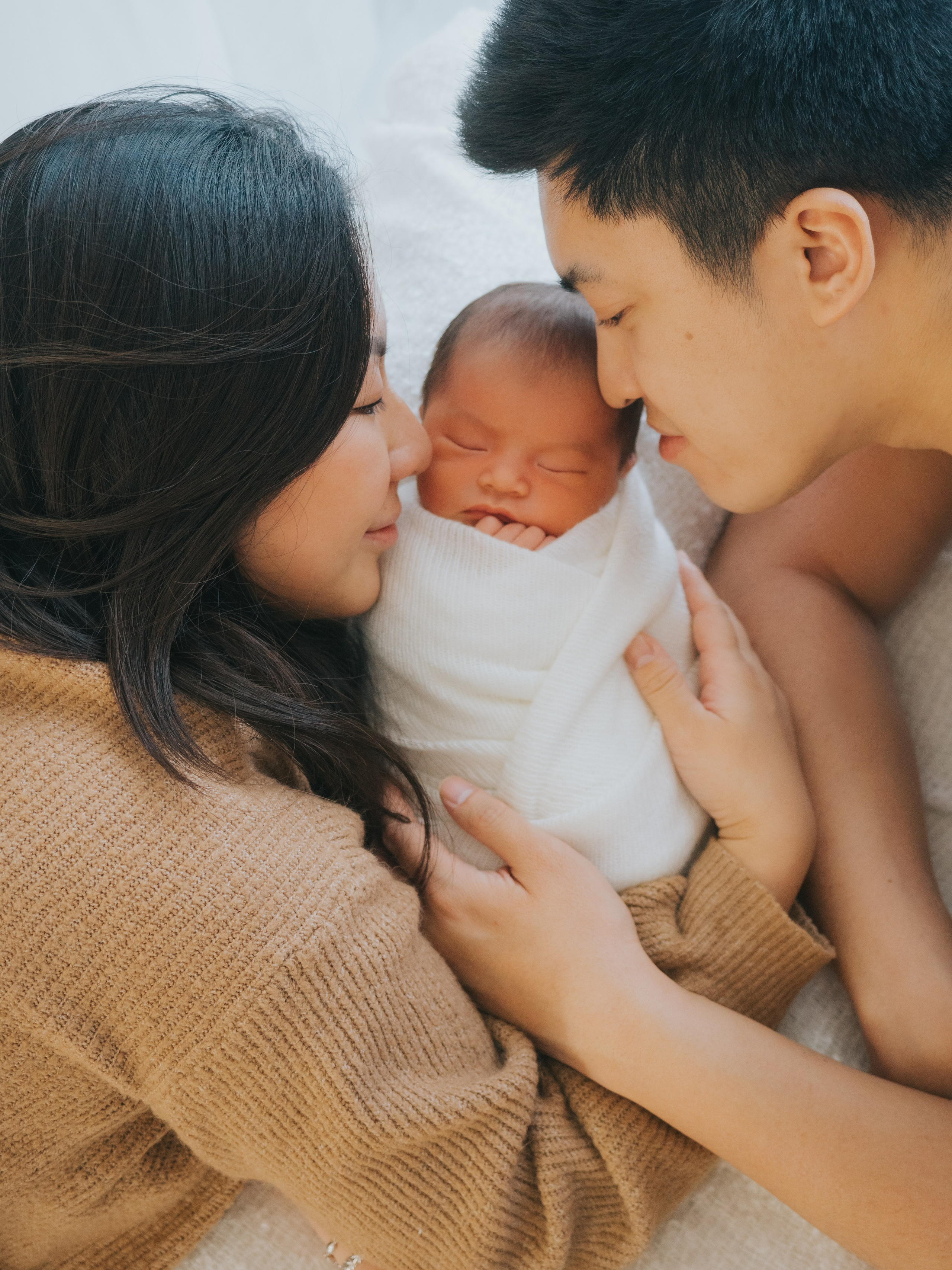Parents holding their newborn.