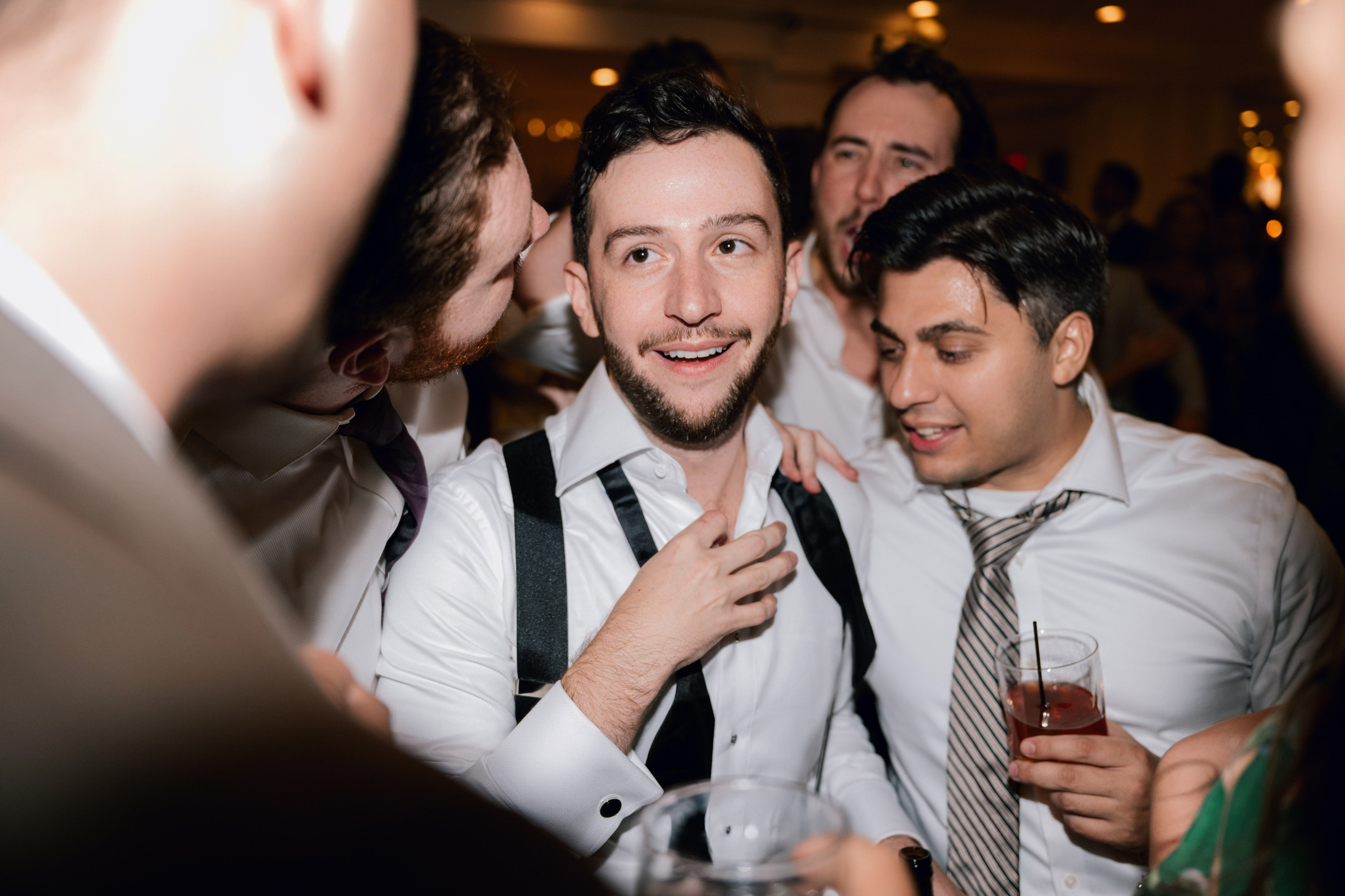 a group of men standing around a table