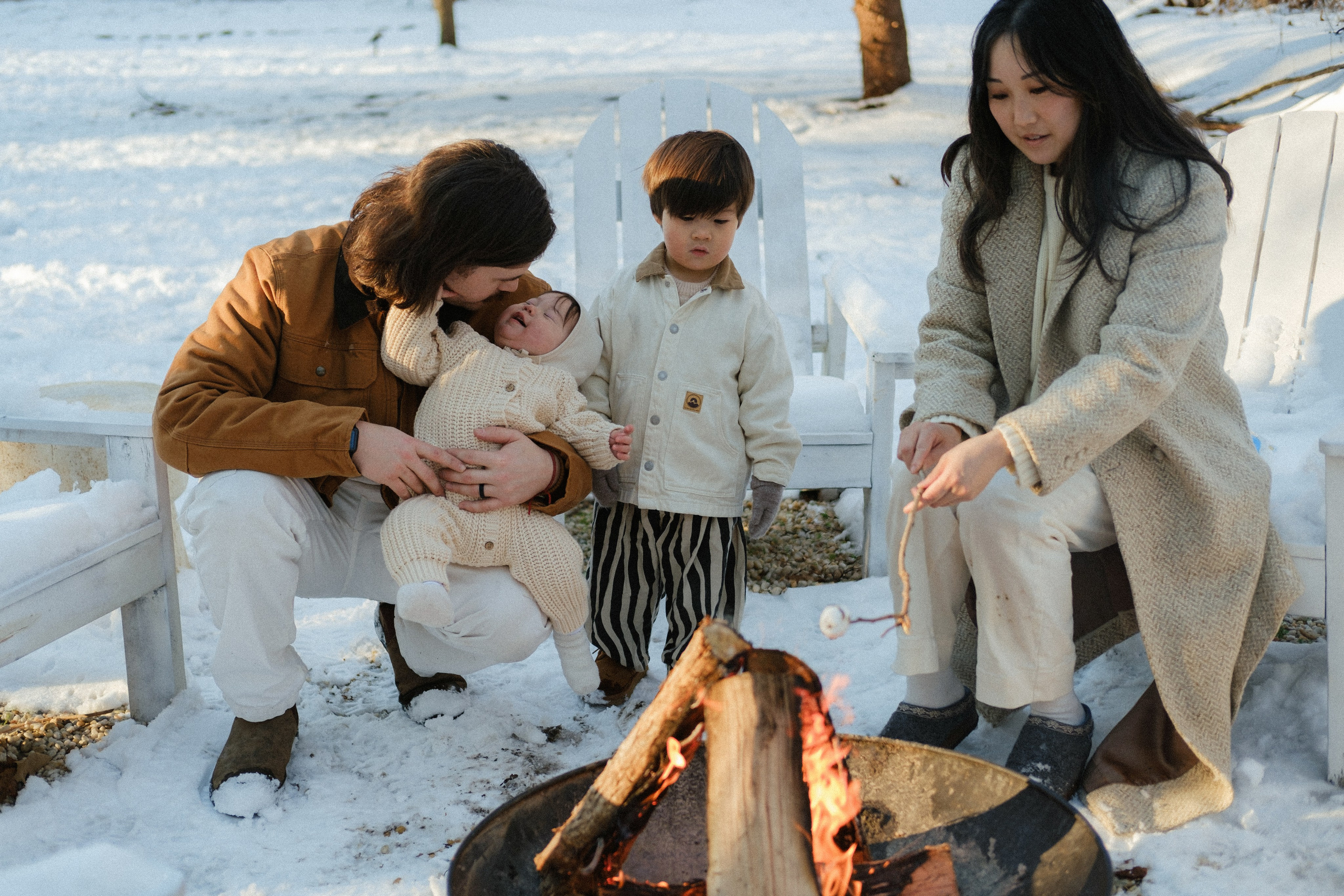 Family gathered around a crackling fire in Richmond, VA — bonding over warm treats and snowy memories.