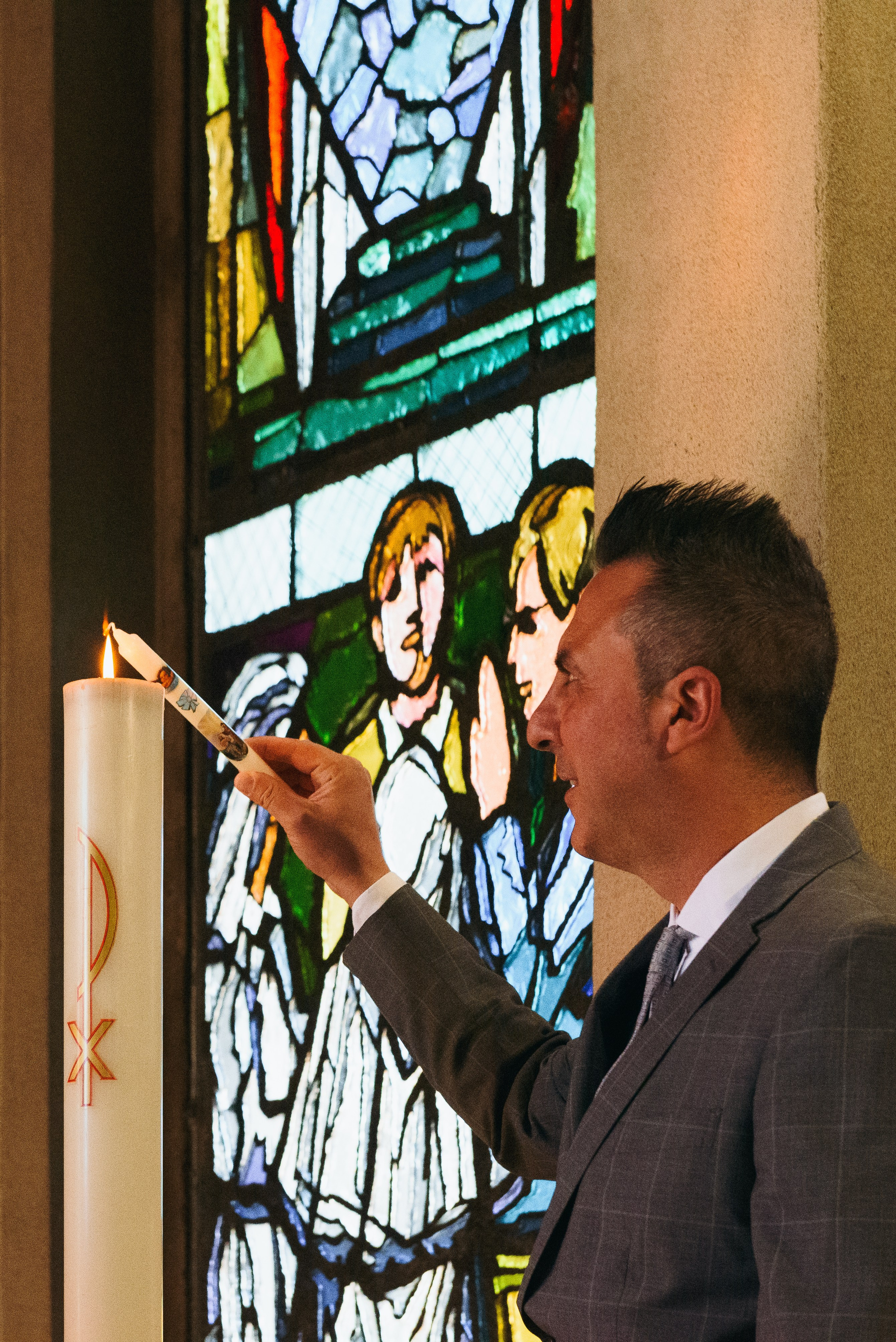 Solemn moment of Christian baptism. Church in Cerro Maggiore. Photographer Milan