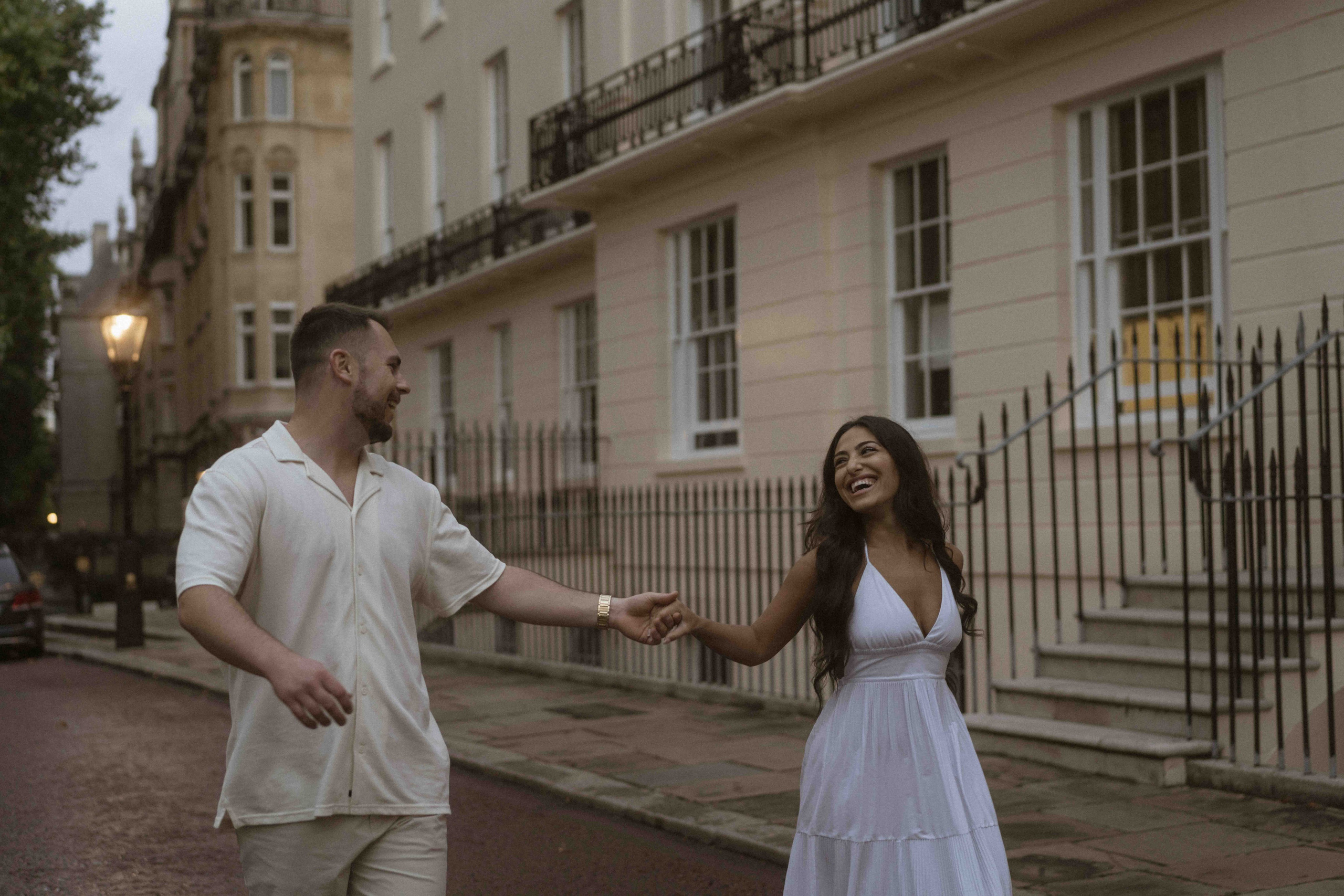 Couple near red London bus after proposal, evening engagement photos London