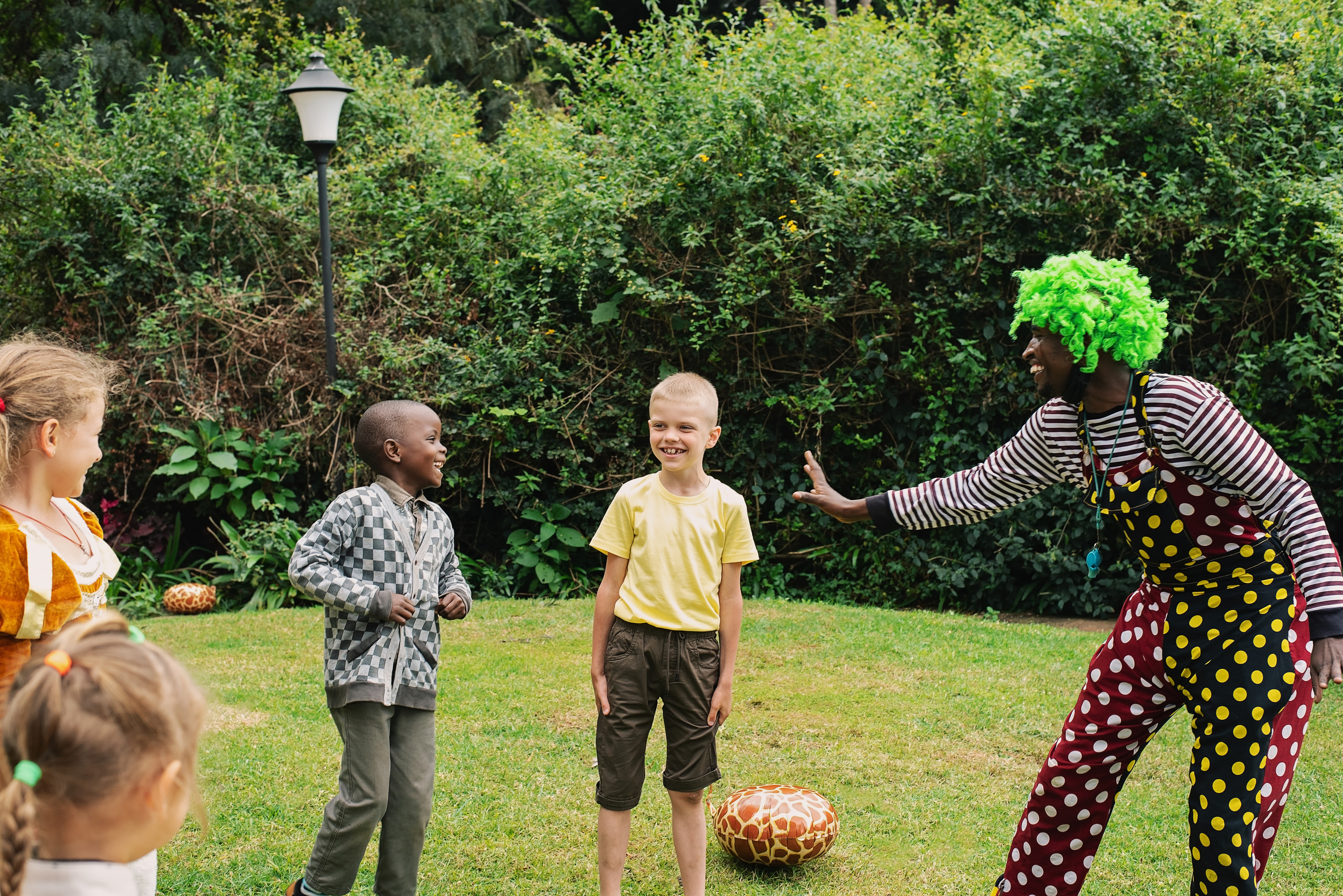 Clown play with boys and girls at the birthday party photo shoot