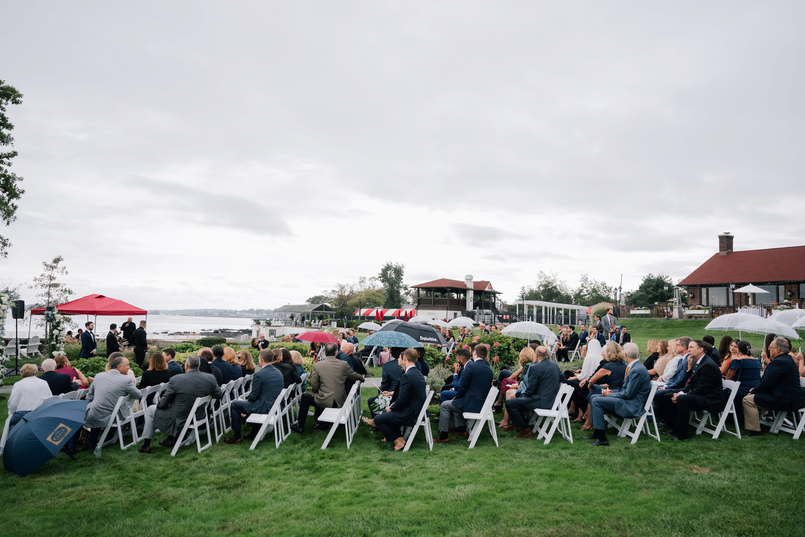 a group of people sitting in chairs under umbrellas
