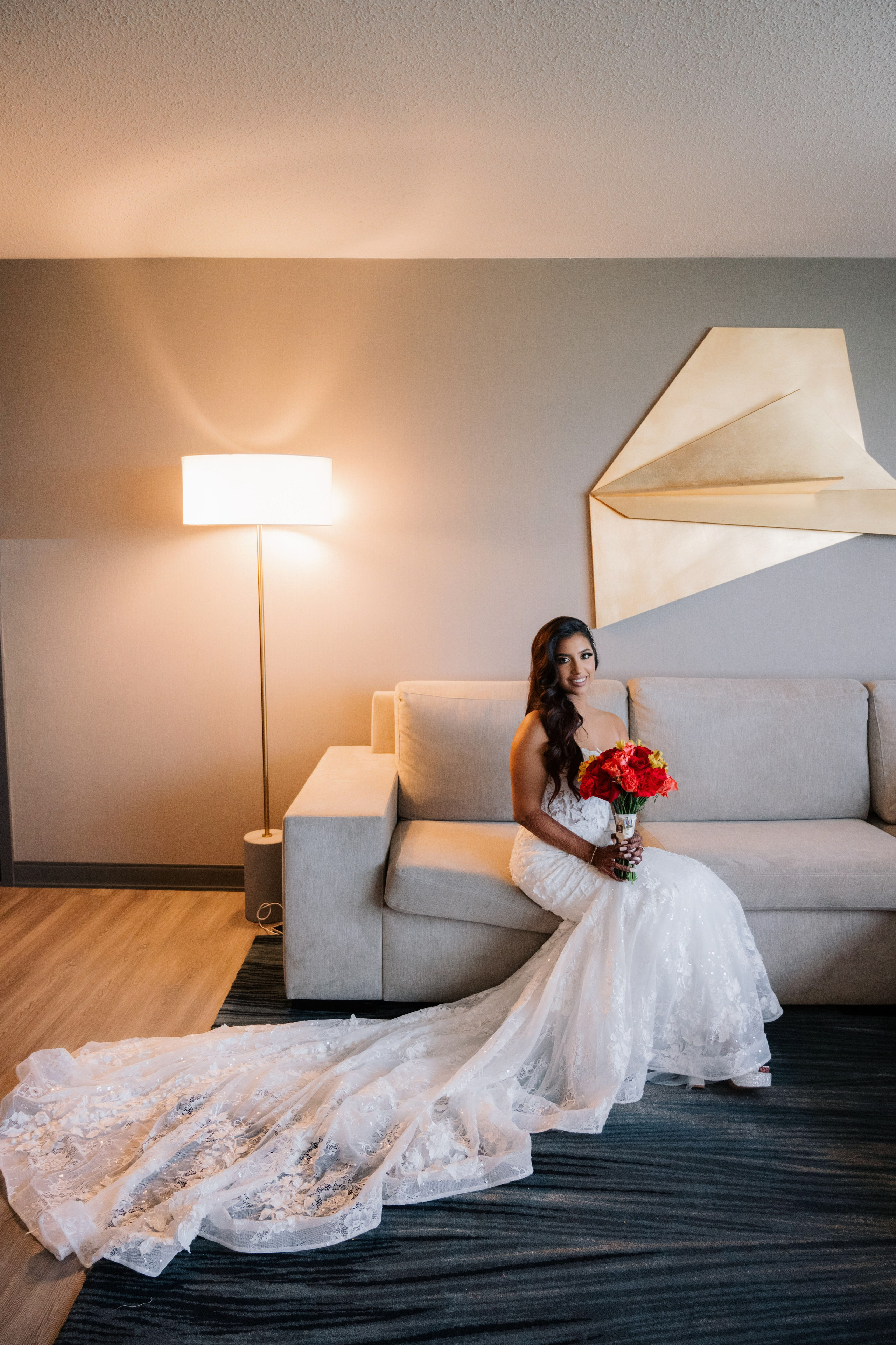a bride sitting on a couch in a hotel room
