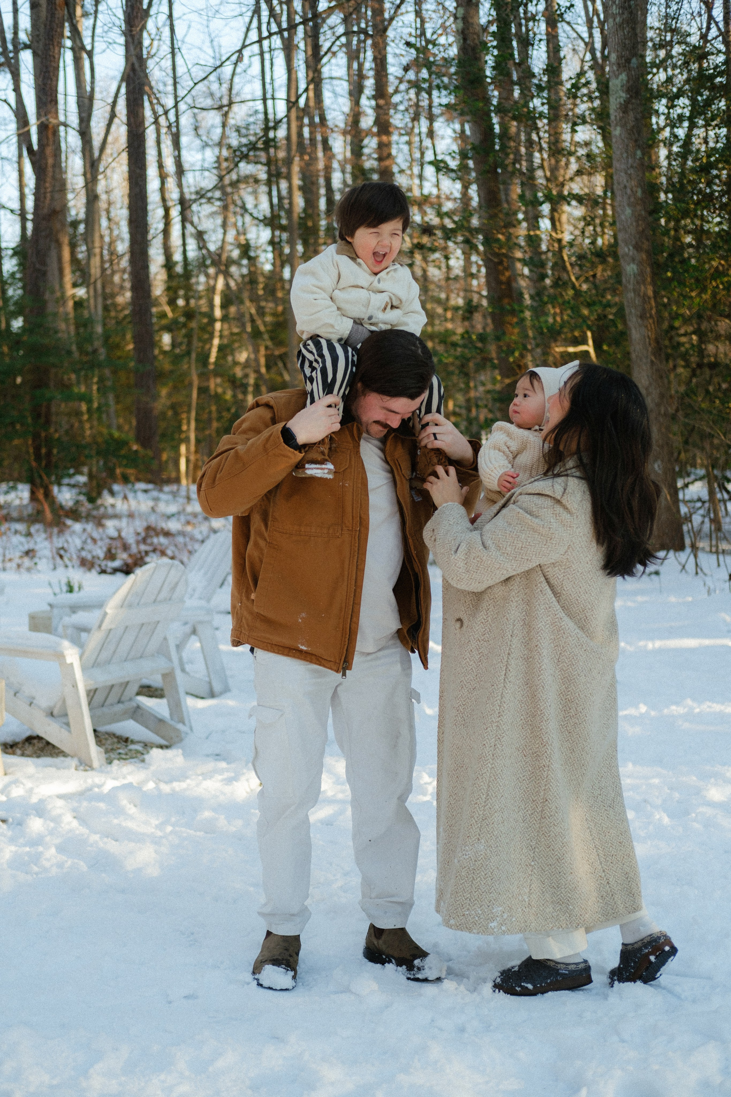 Warm family hugs and playful giggles in the snow outside Richmond, VA — documenting connection in a winter wonderland.