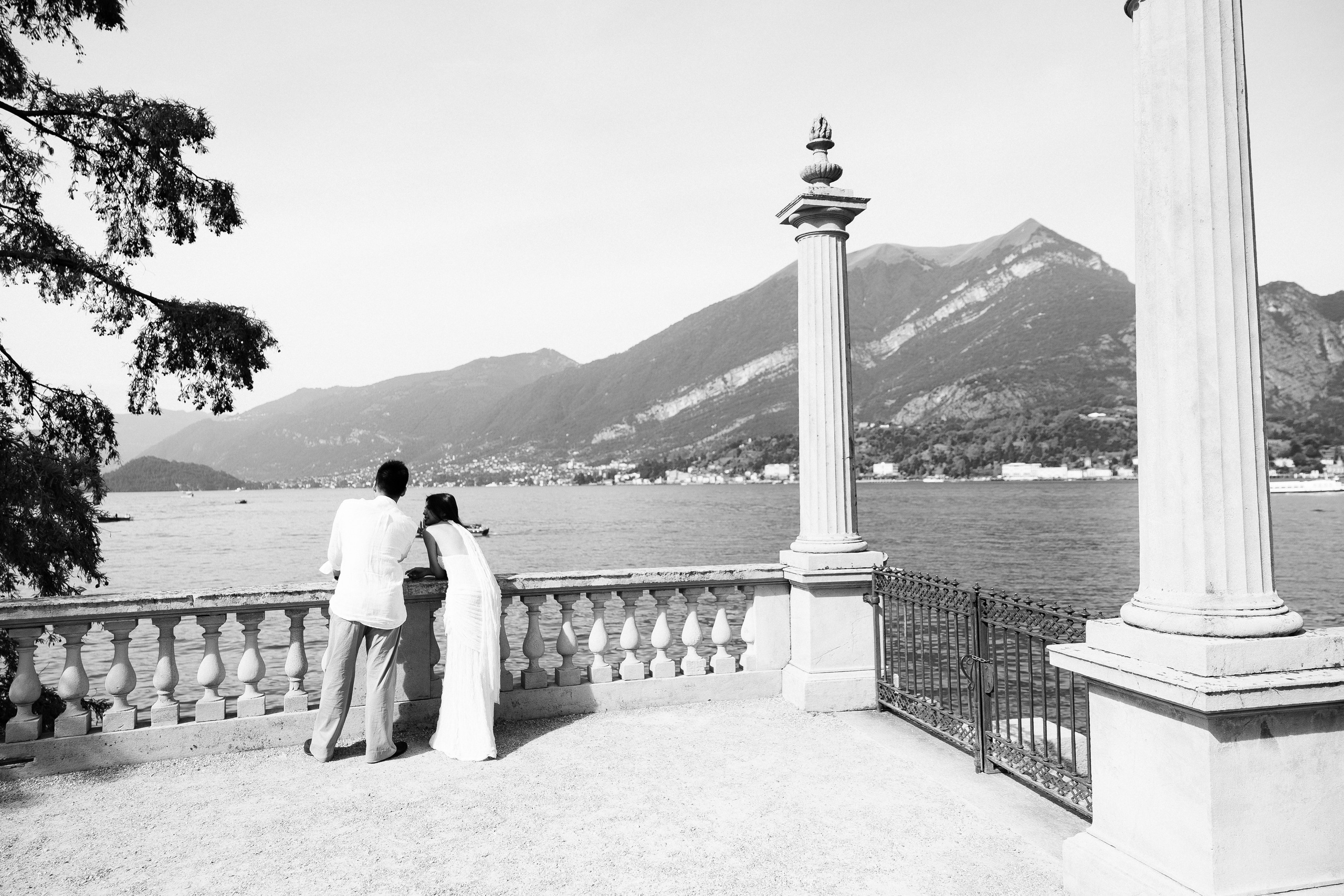 Black and white photograph of a couple beside the Villa Melzi lakeside balustrade