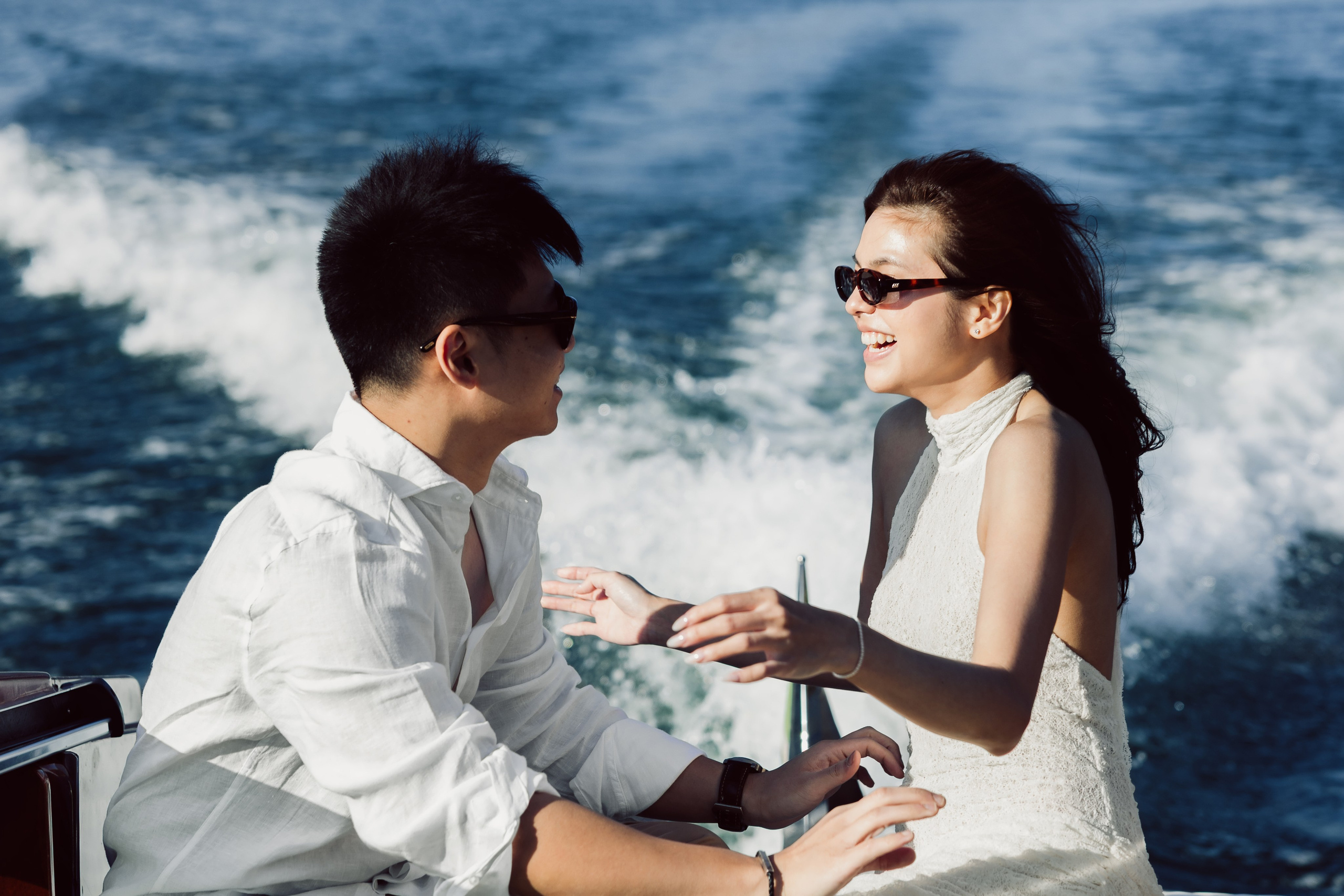 Romantic couple laughing together during a private boat ride on Lake Como