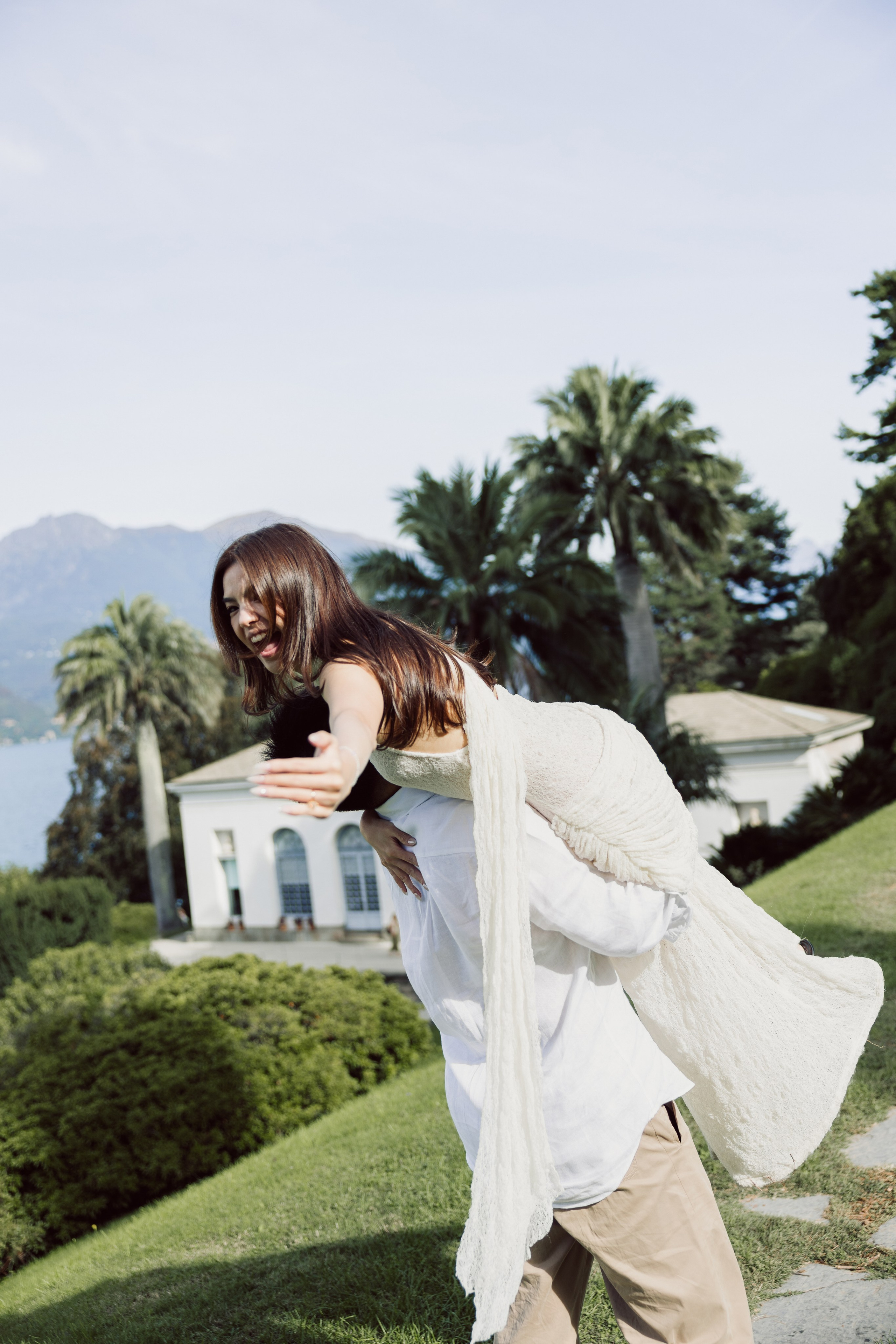 Man lifting his partner in the gardens of Villa Melzi during a romantic photoshoot