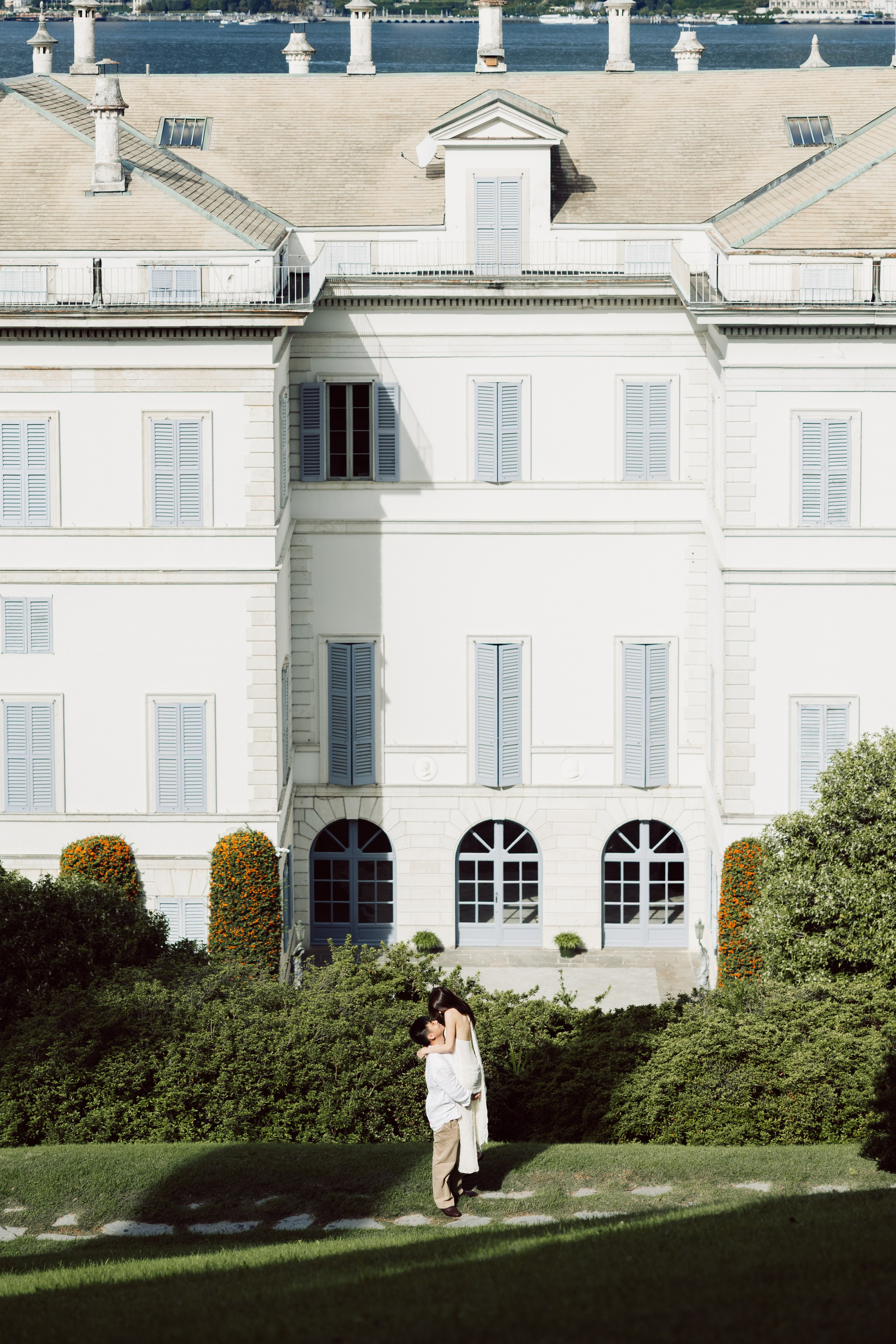 Couple embracing in the gardens of Villa Melzi overlooking Lake Como