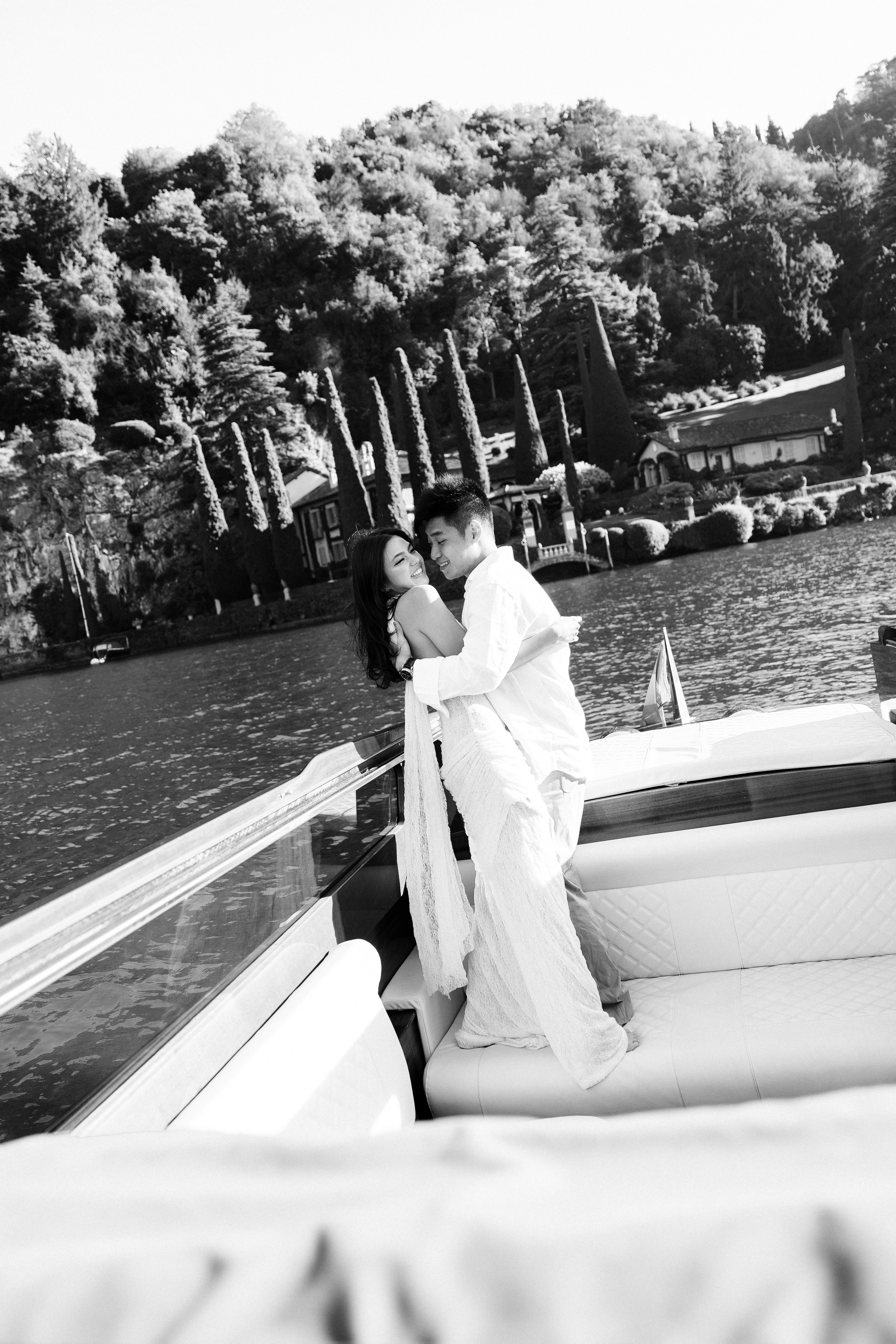 Romantic black and white couple portrait on a private boat at Lake Como