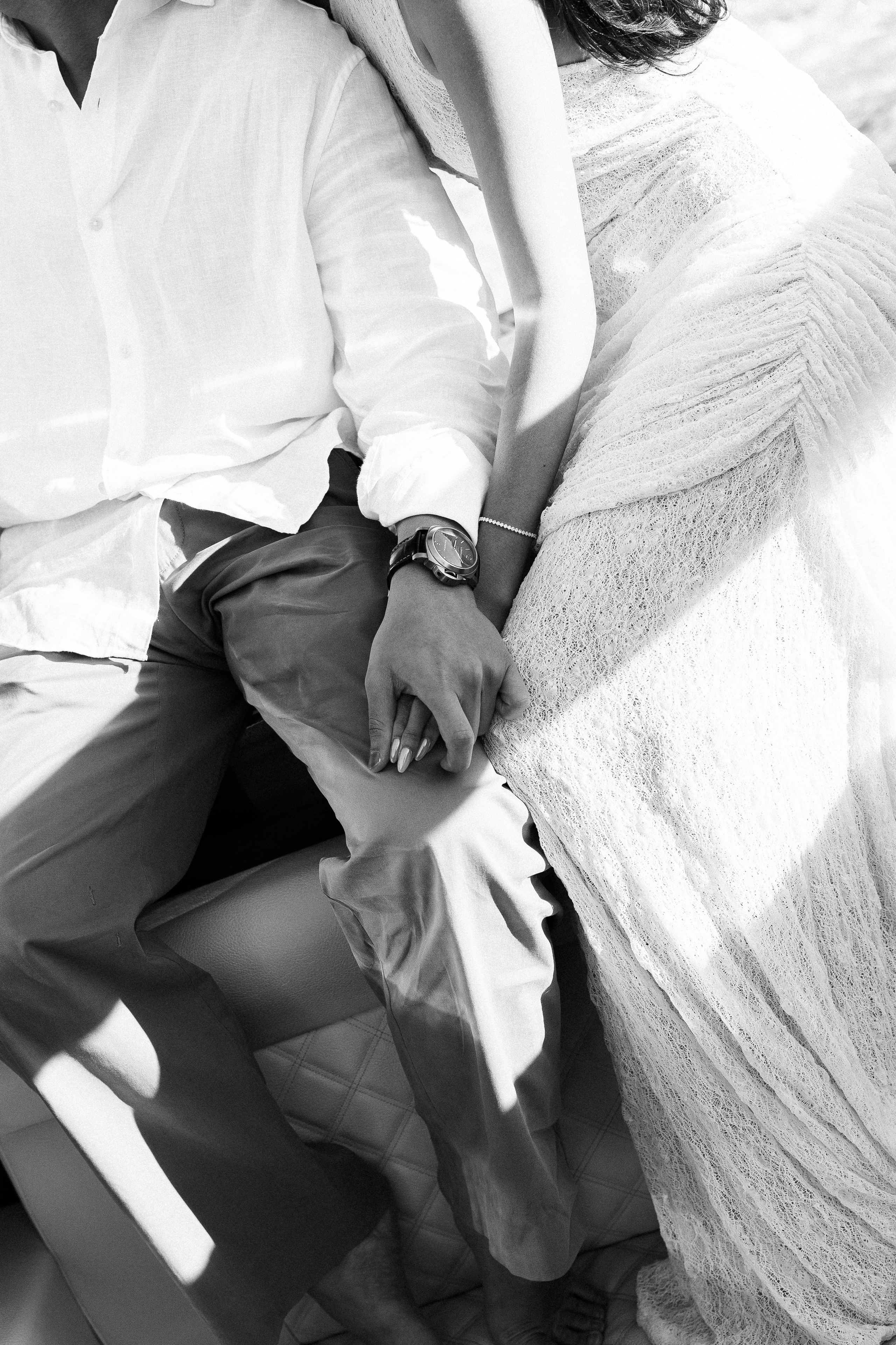 Black and white close-up of a couple holding hands during their Lake Como love story photoshoot