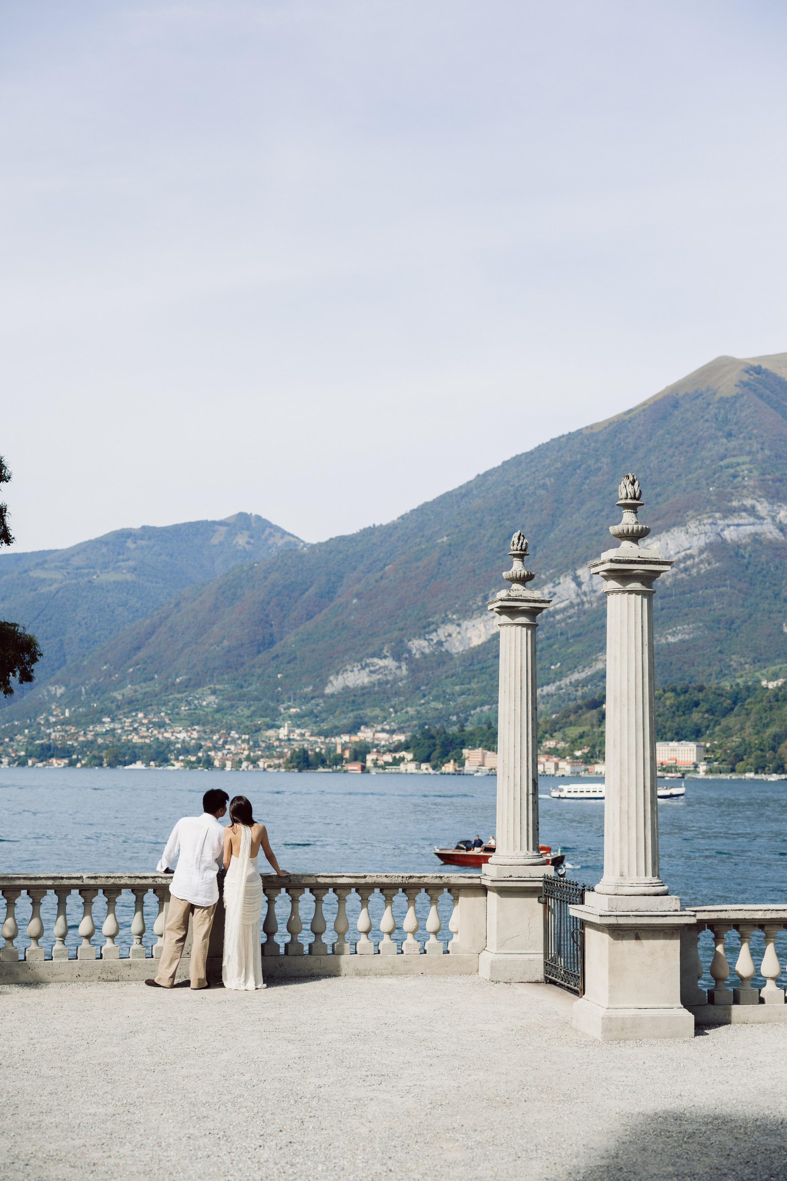 Couple standing together on the Villa Melzi terrace with Lake Como behind them