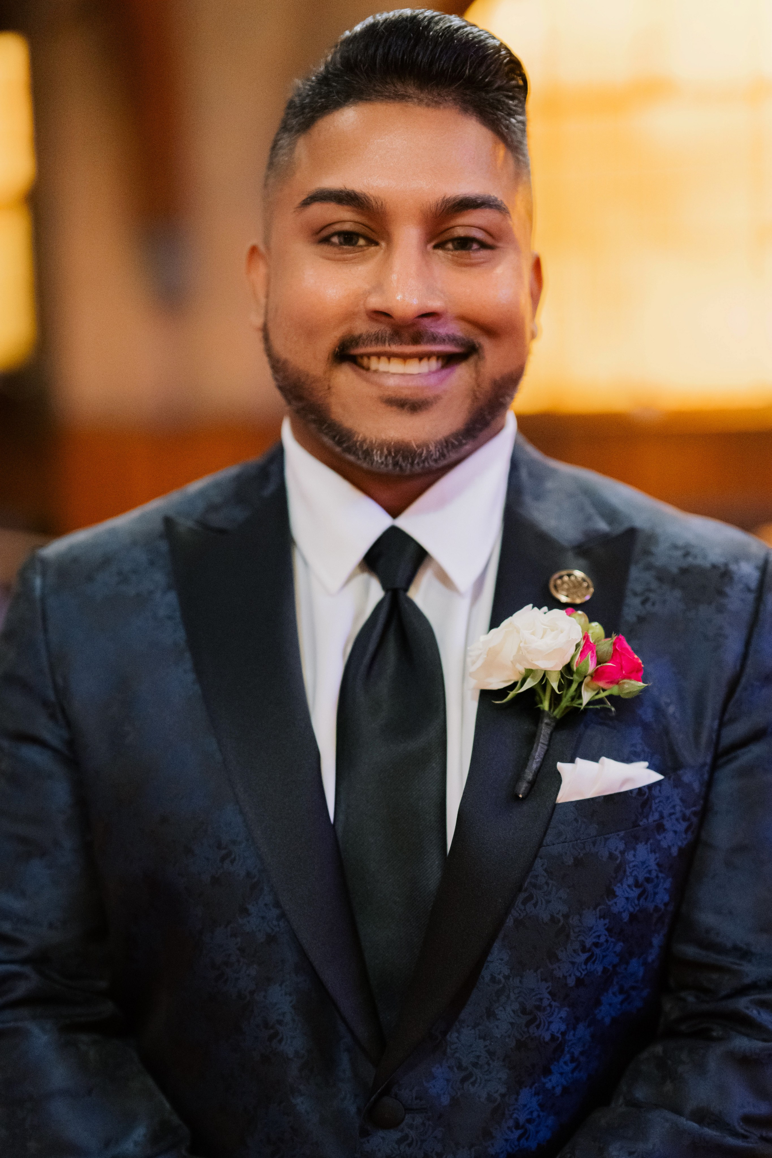 a man in a suit and tie smiling
