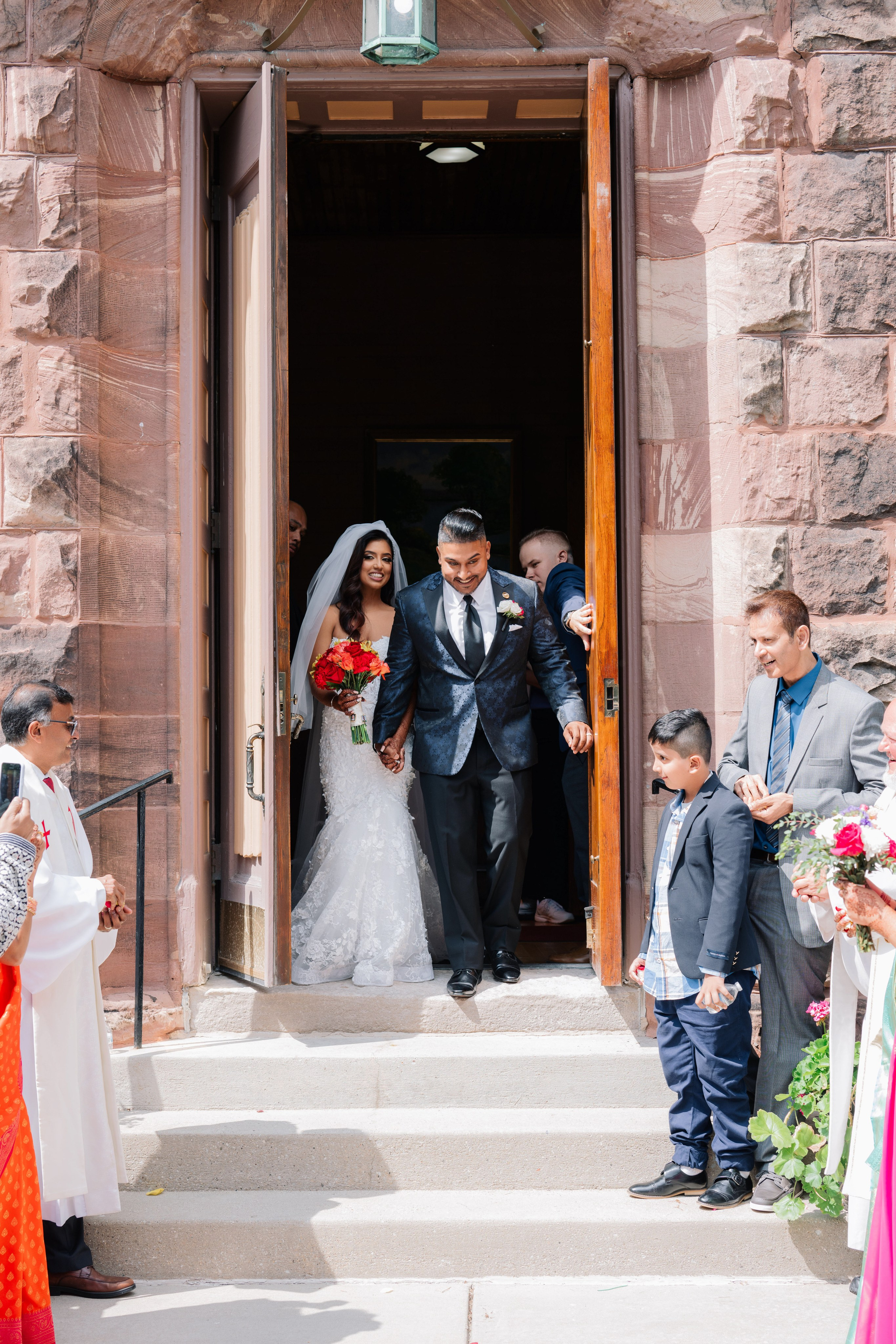 a bride and groom are leaving the church
