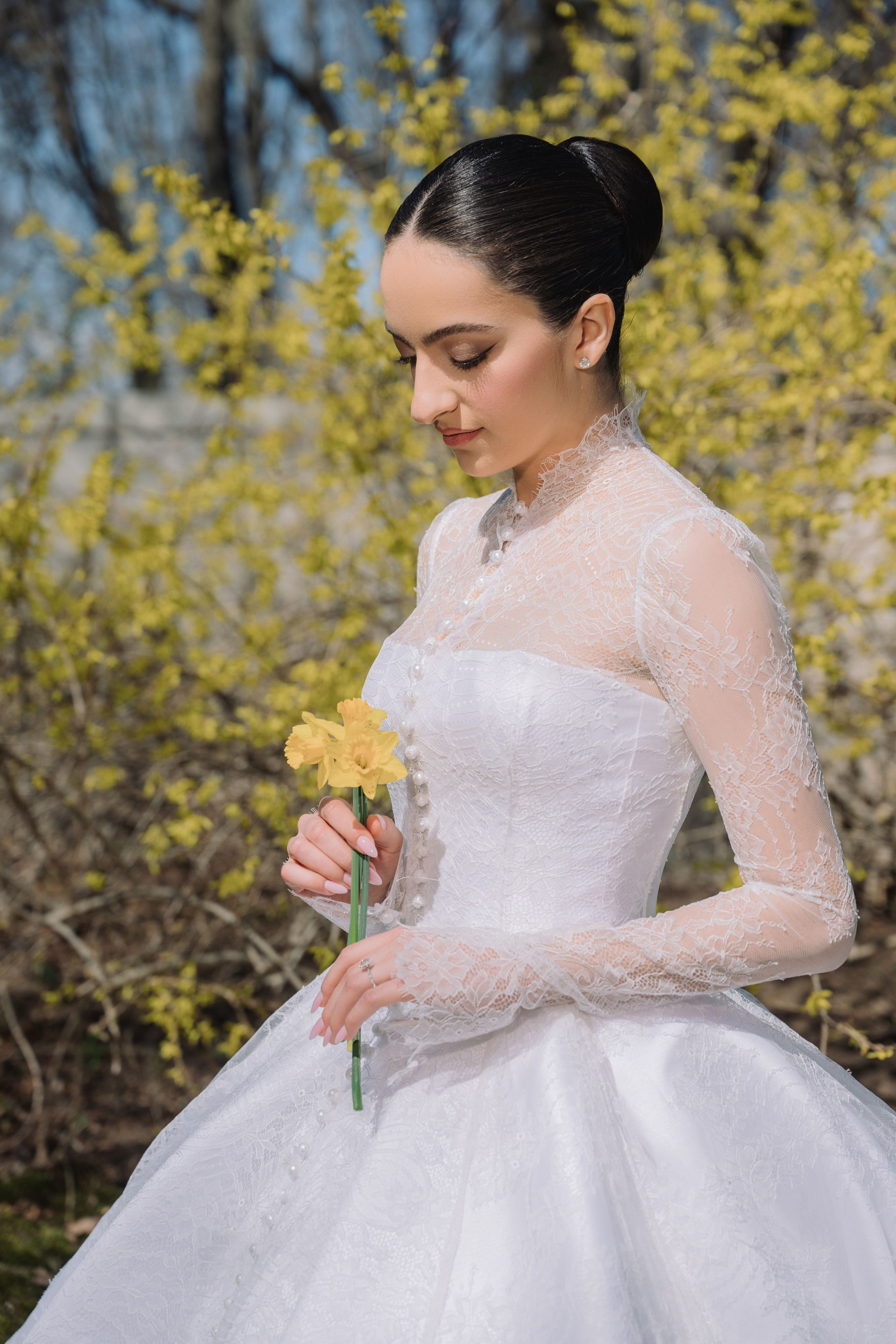 a woman in a white dress holding a flower