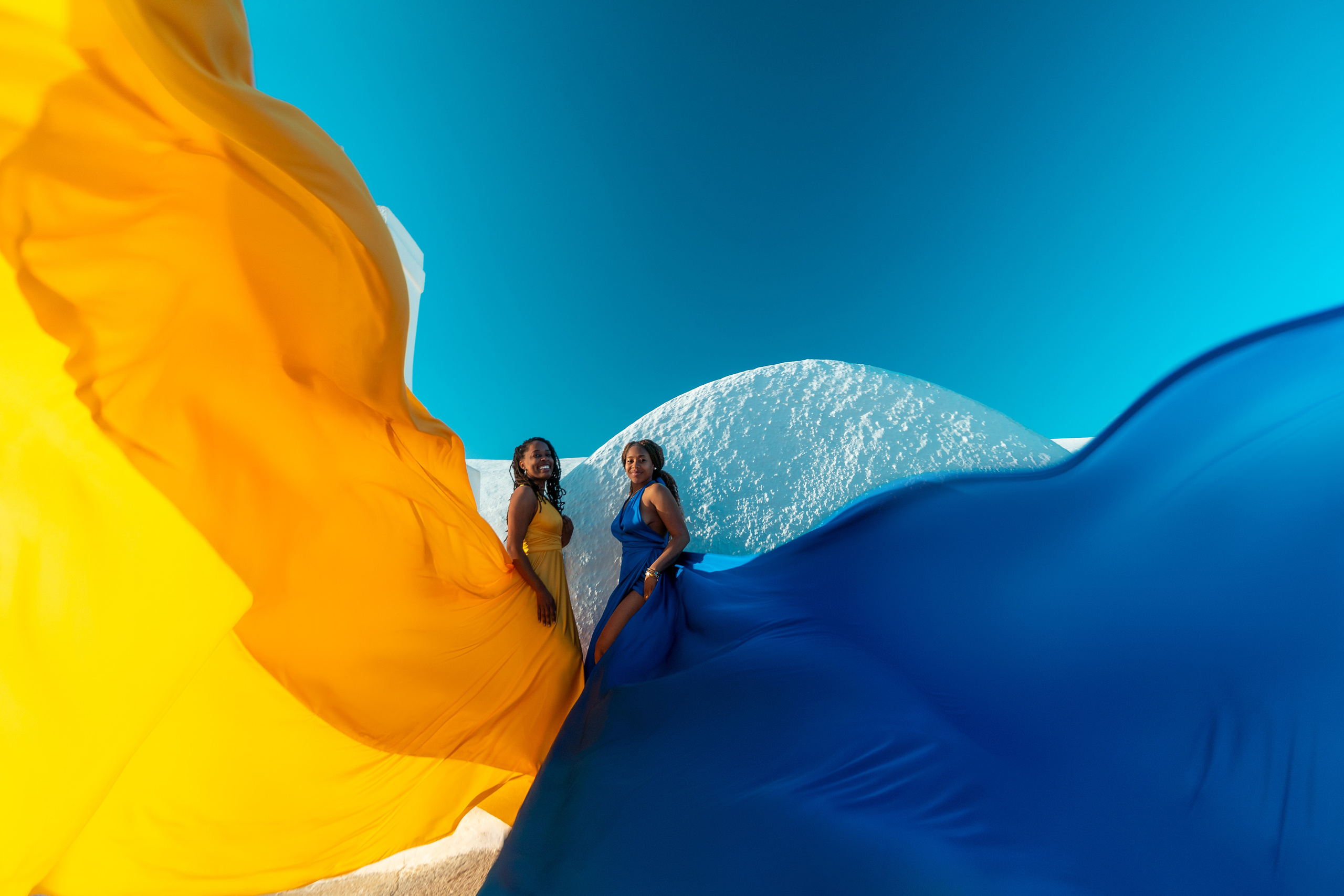 Group photoshoot in flying dress in Oia. Photographer in Santorini SokoLOVE Alex| Flying Dress Santorini