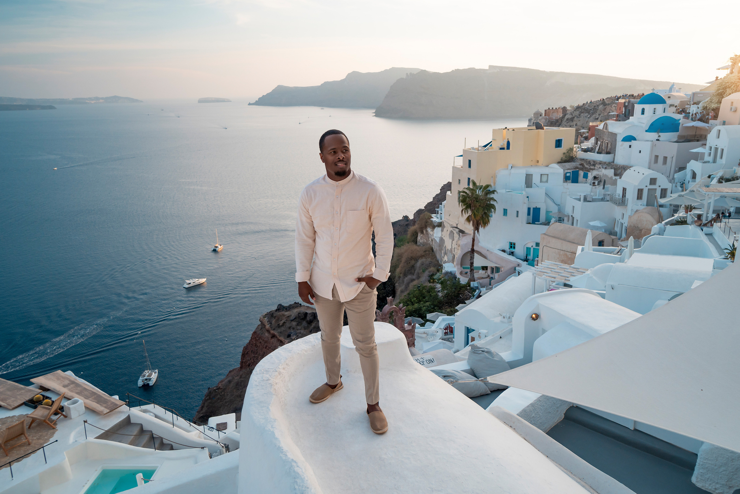 Photo session in Oia, Santorini at sunset, cherry flying dress. Photographer in Santorini SokoLOVE Alex| Flying Dress Santorini