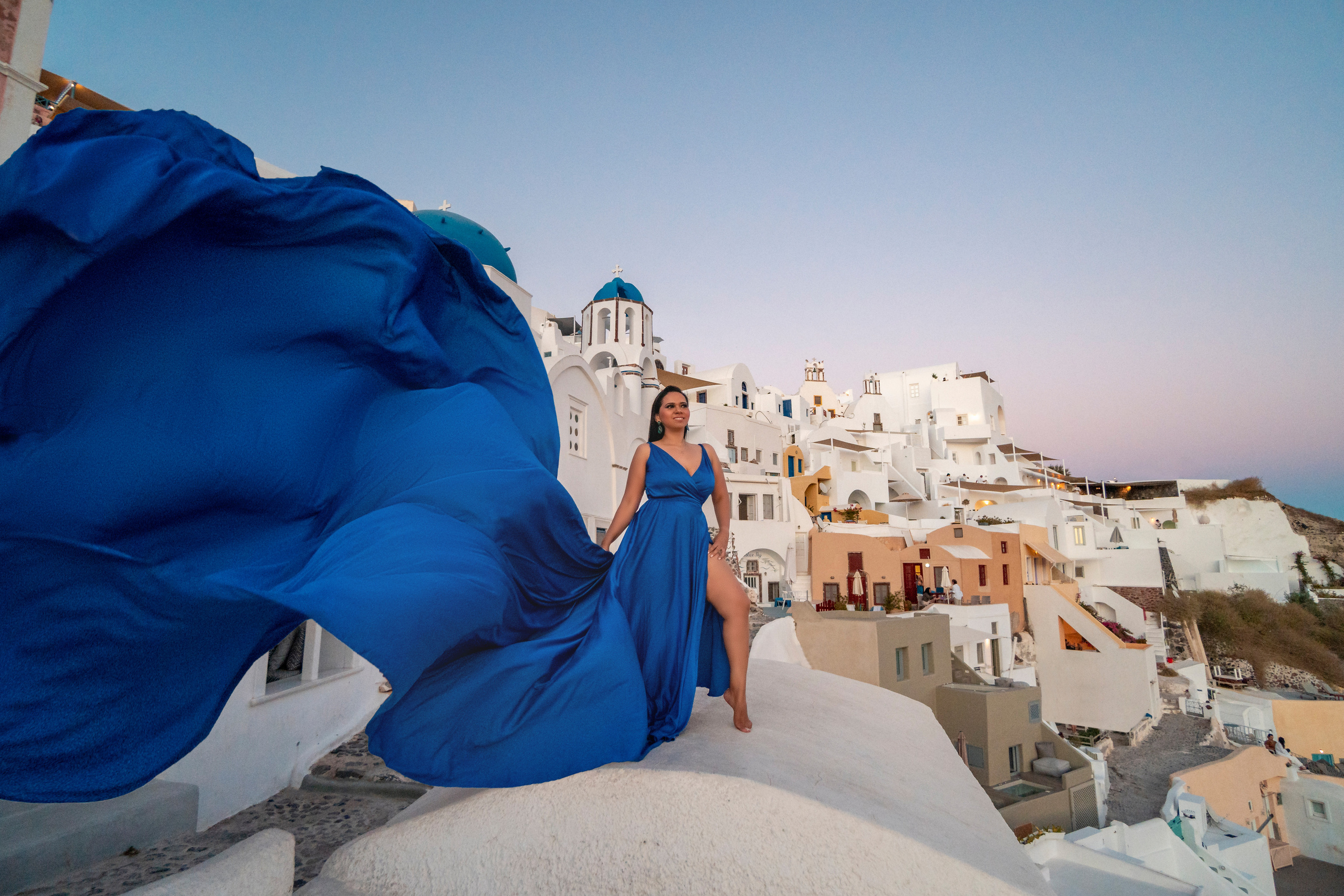 Suset in Oia blue silk flying dress. Photographer in Santorini SokoLOVE Alex| Flying Dress Santorini