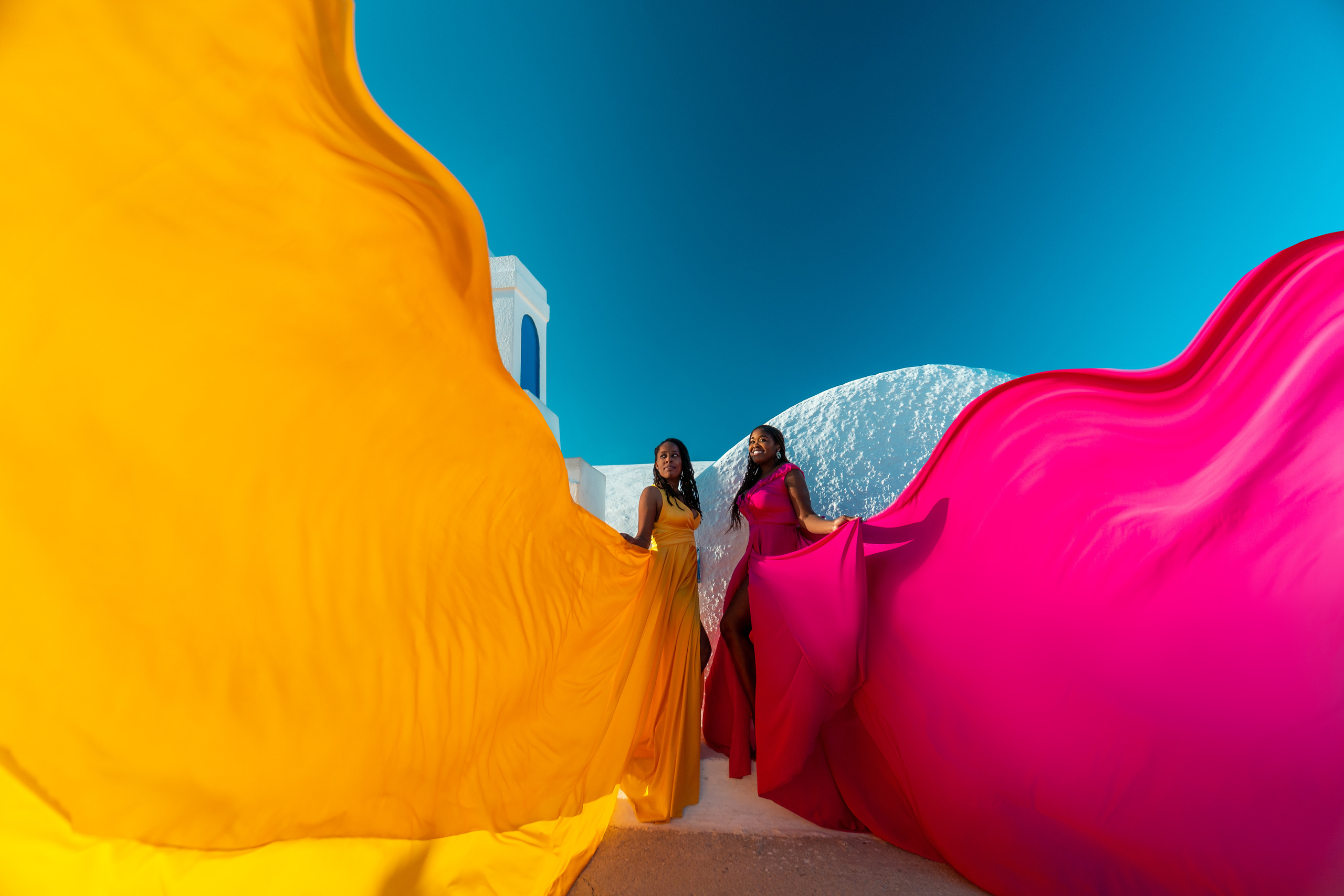 Group photoshoot in flying dress in Oia. Photographer in Santorini SokoLOVE Alex| Flying Dress Santorini