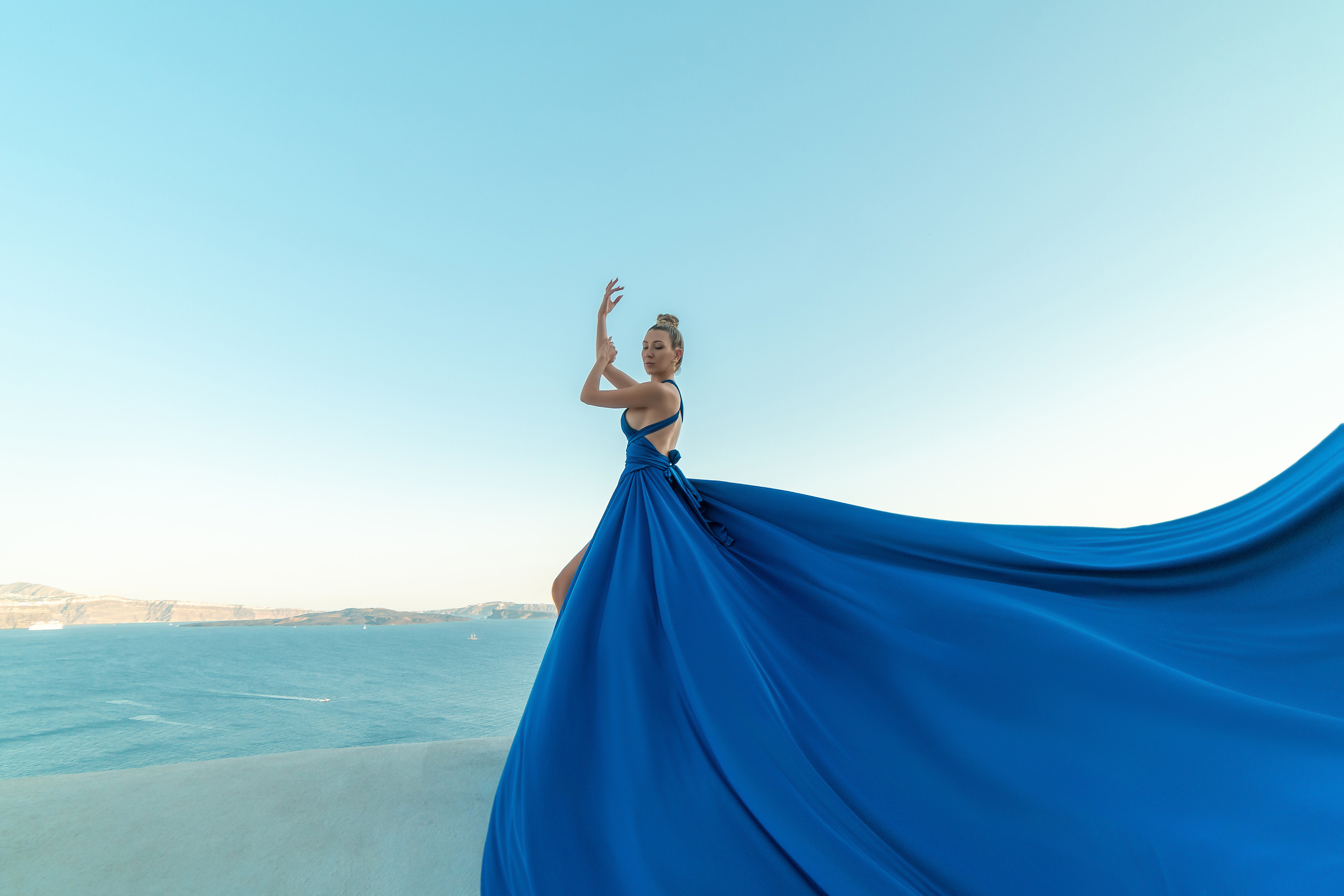 Suset in Oia blue silk flying dress. Photographer in Santorini SokoLOVE Alex| Flying Dress Santorini