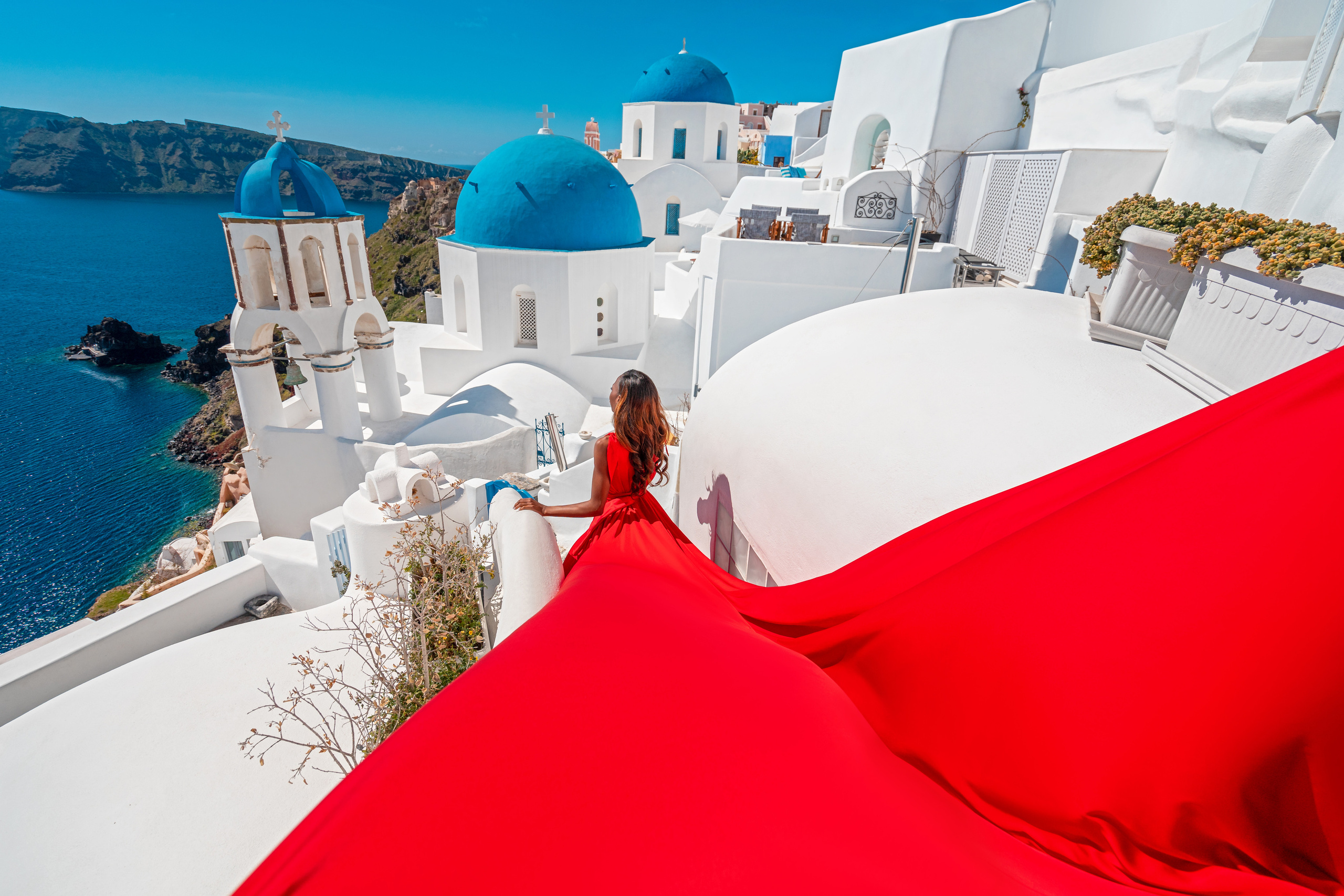 Red flying dress in Santorini