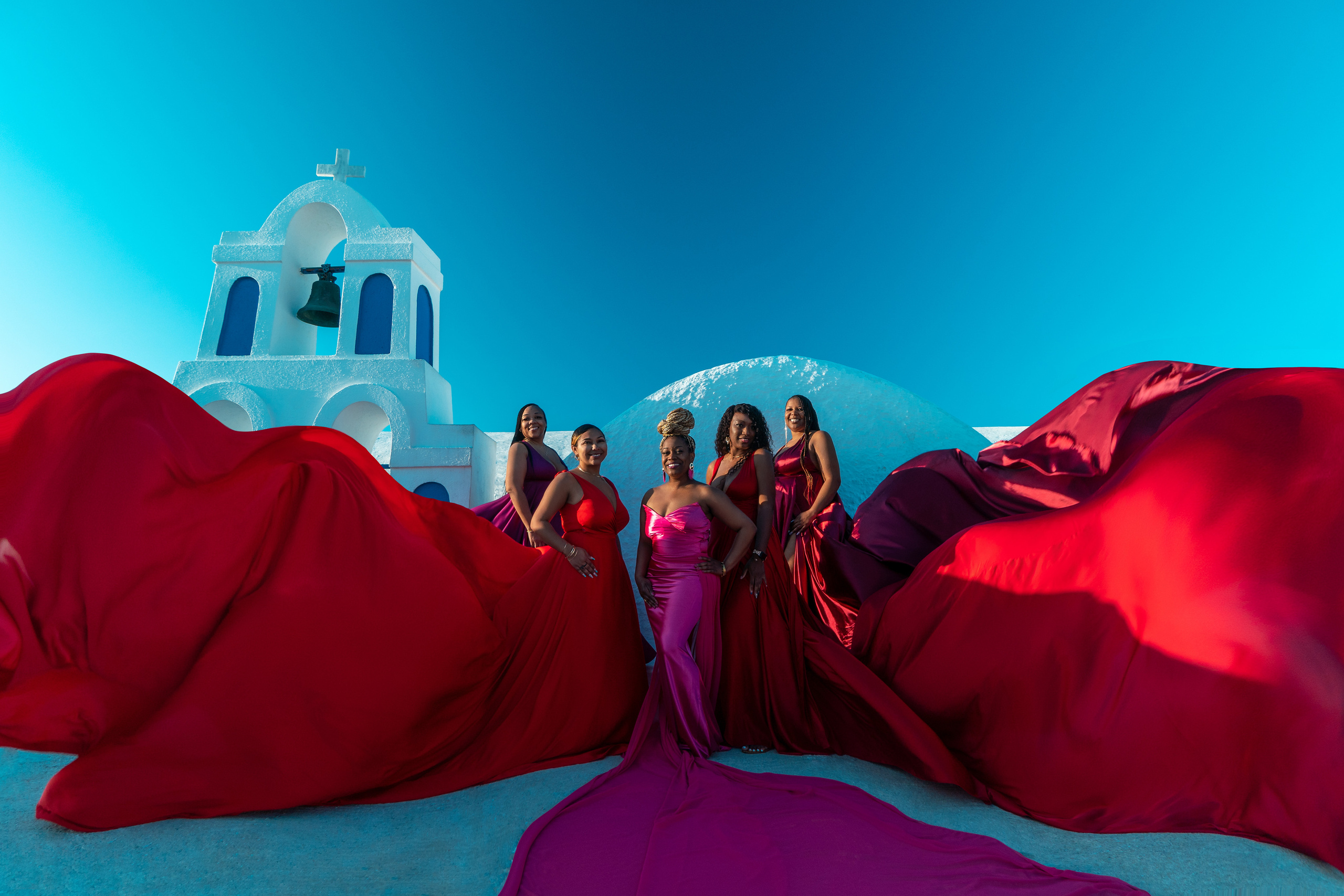 Group photoshoot in flying dress in Oia. Photographer in Santorini SokoLOVE Alex| Flying Dress Santorini