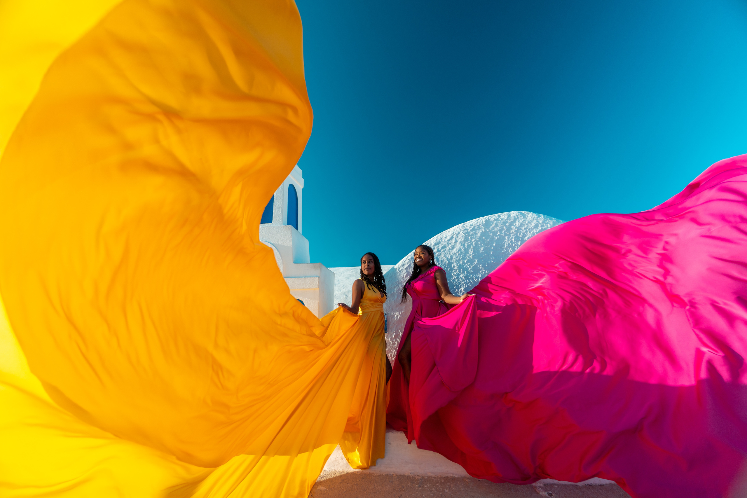 Group photoshoot in flying dress in Oia. Photographer in Santorini SokoLOVE Alex| Flying Dress Santorini