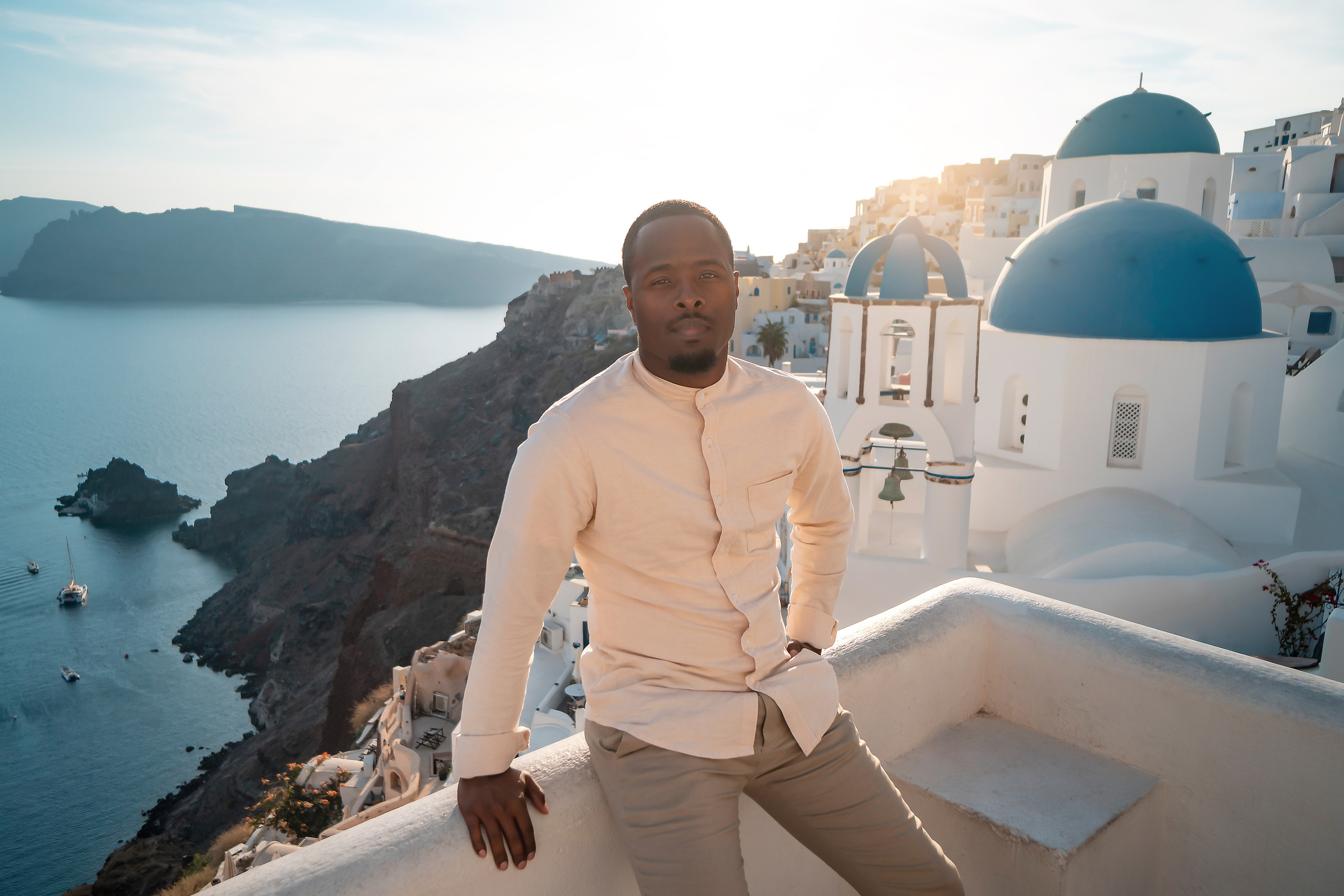 Photo session in Oia, Santorini at sunset, cherry flying dress. Photographer in Santorini SokoLOVE Alex| Flying Dress Santorini