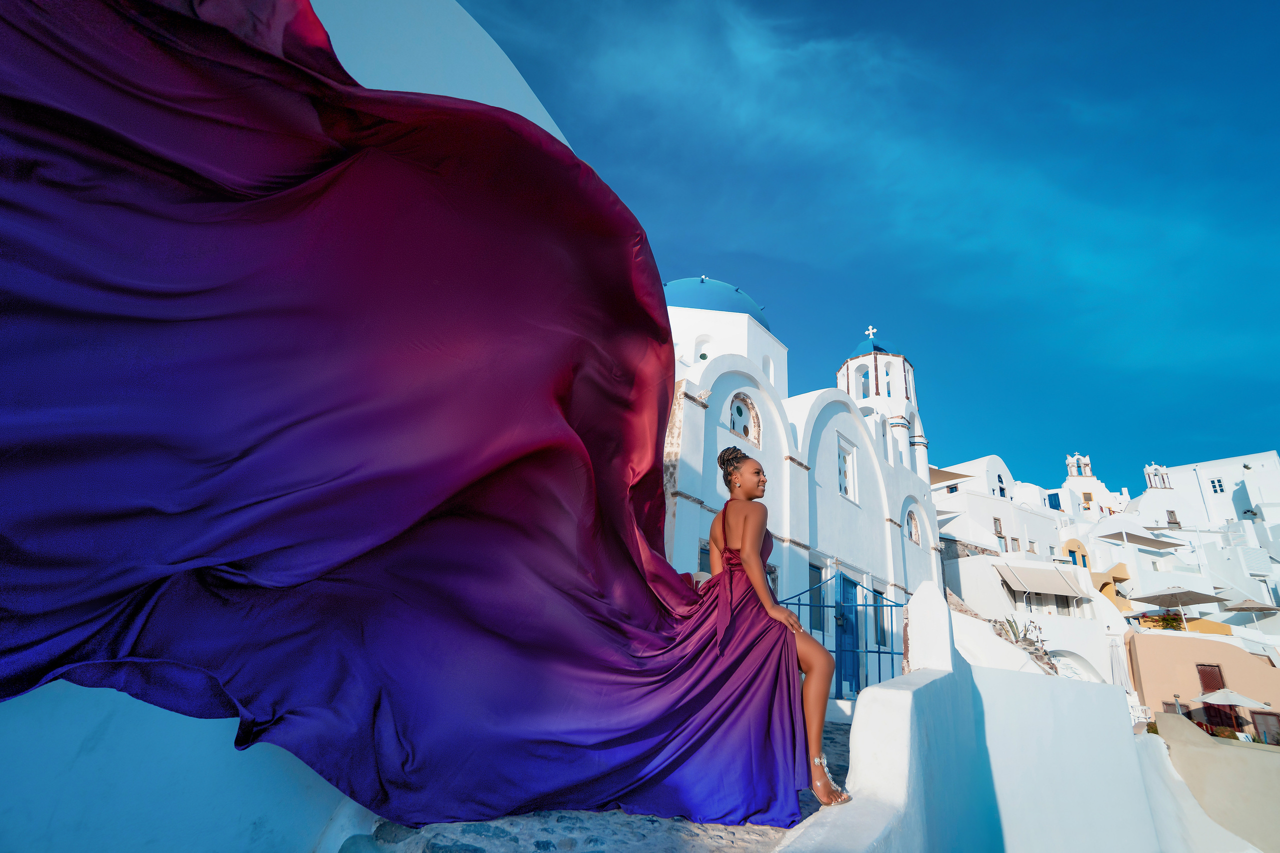 Photo session in Oia, Santorini at sunset, cherry flying dress. Photographer in Santorini SokoLOVE Alex| Flying Dress Santorini