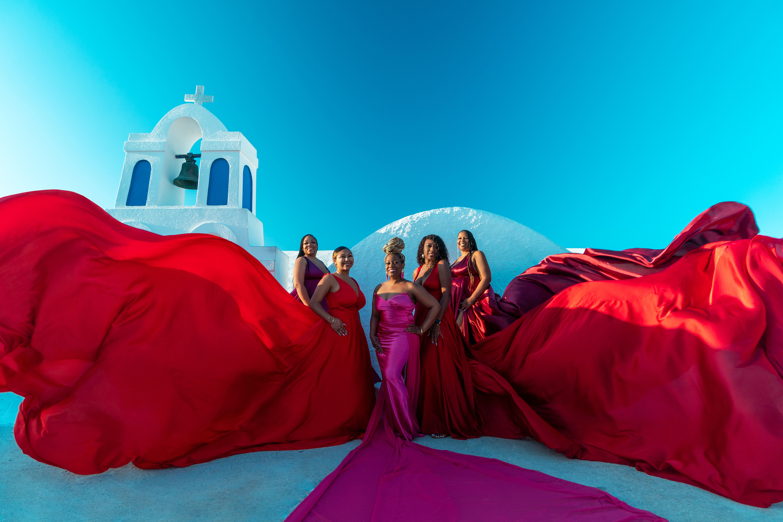 Group photoshoot in flying dress in Oia. Photographer in Santorini SokoLOVE Alex| Flying Dress Santorini