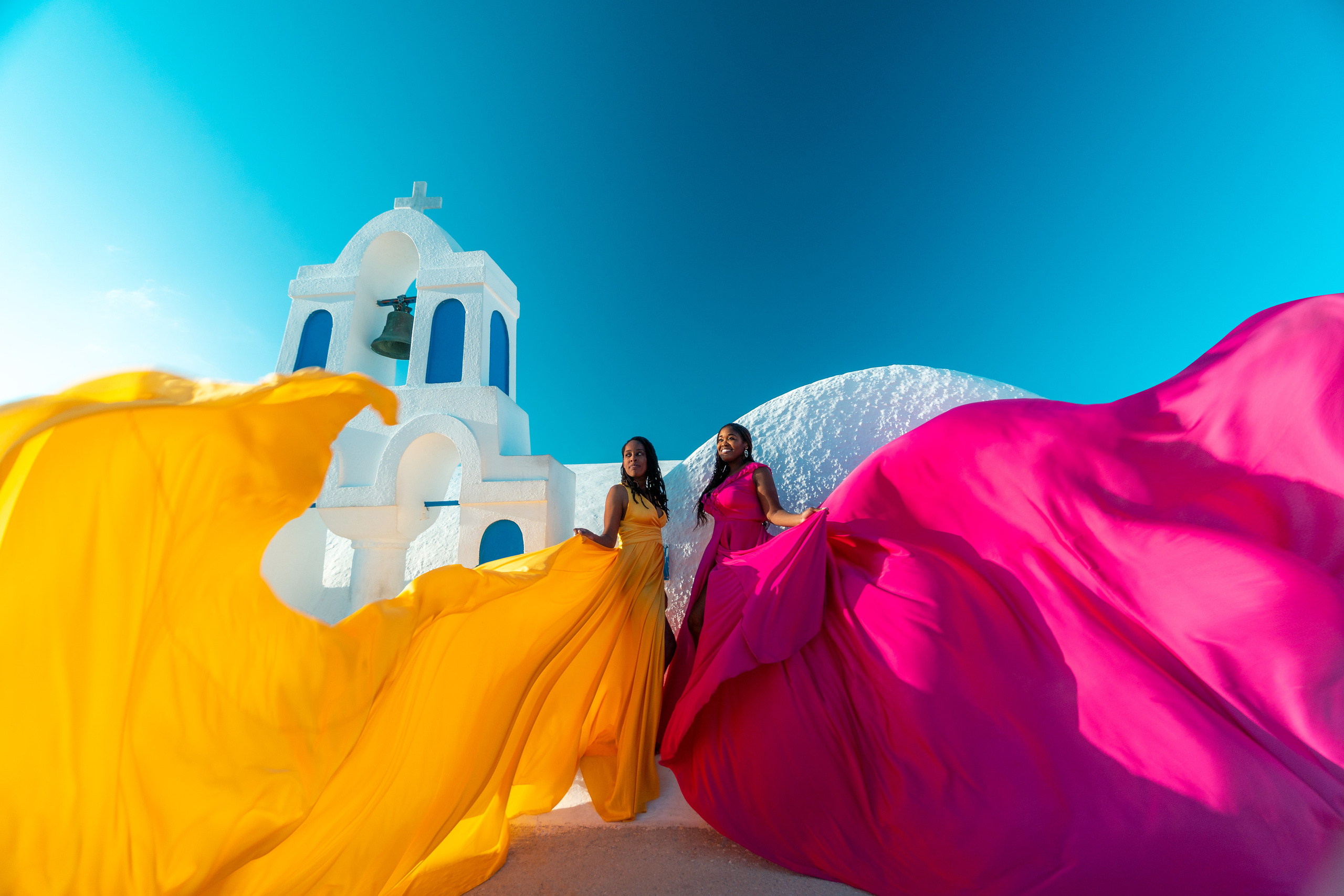 Group photoshoot in flying dress in Oia. Photographer in Santorini SokoLOVE Alex| Flying Dress Santorini