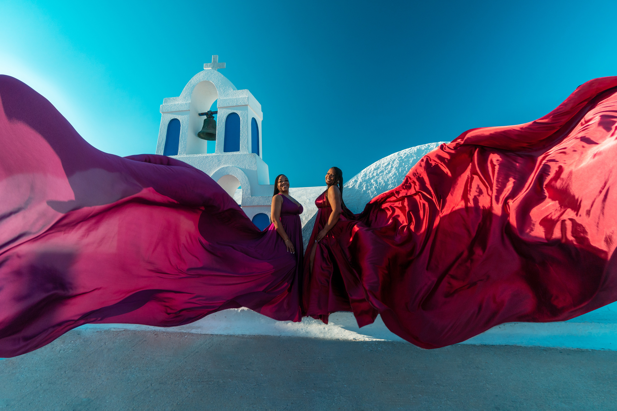 Group photoshoot in flying dress in Oia. Photographer in Santorini SokoLOVE Alex| Flying Dress Santorini