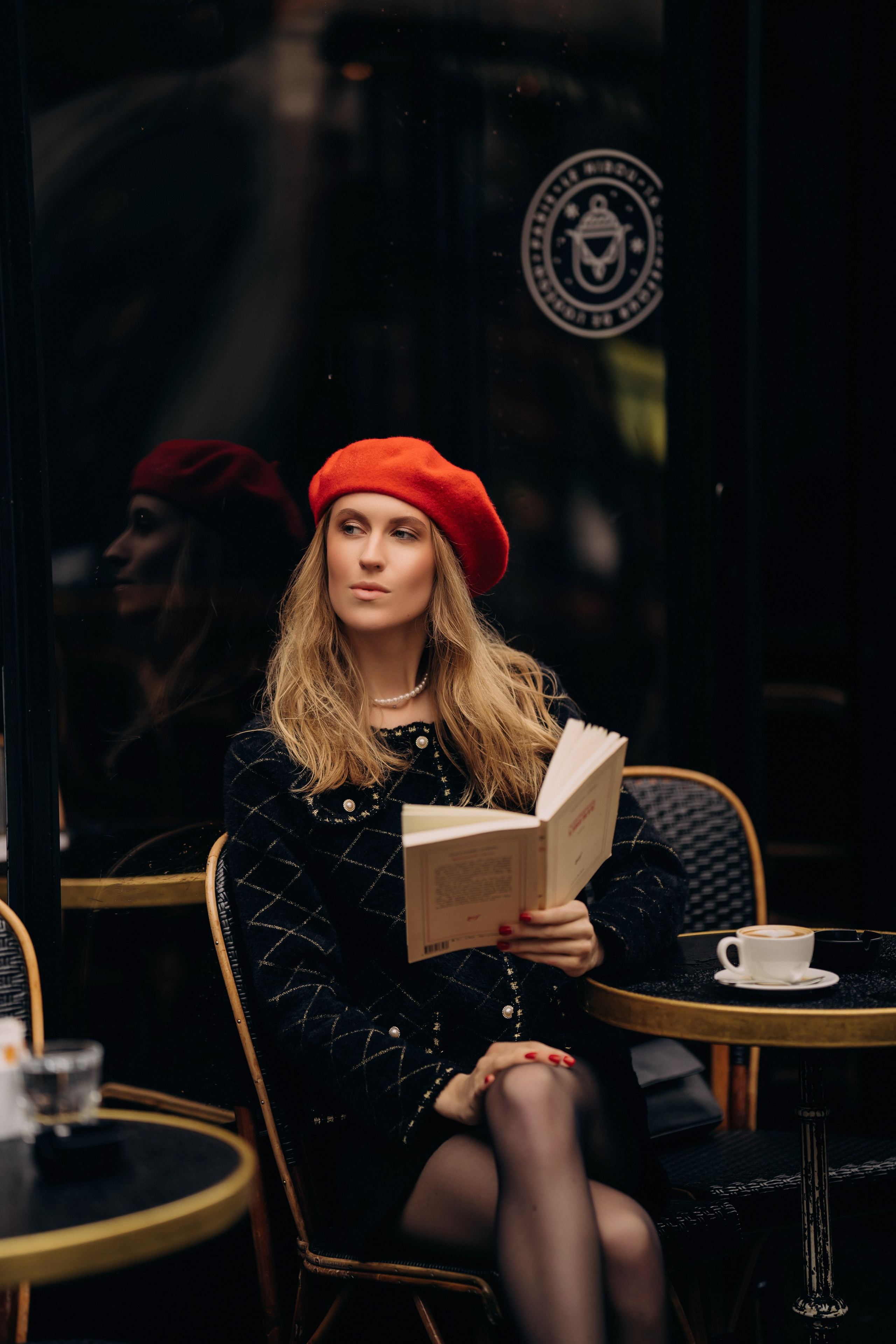 Photo shoot in a cozy café with a book in hand.