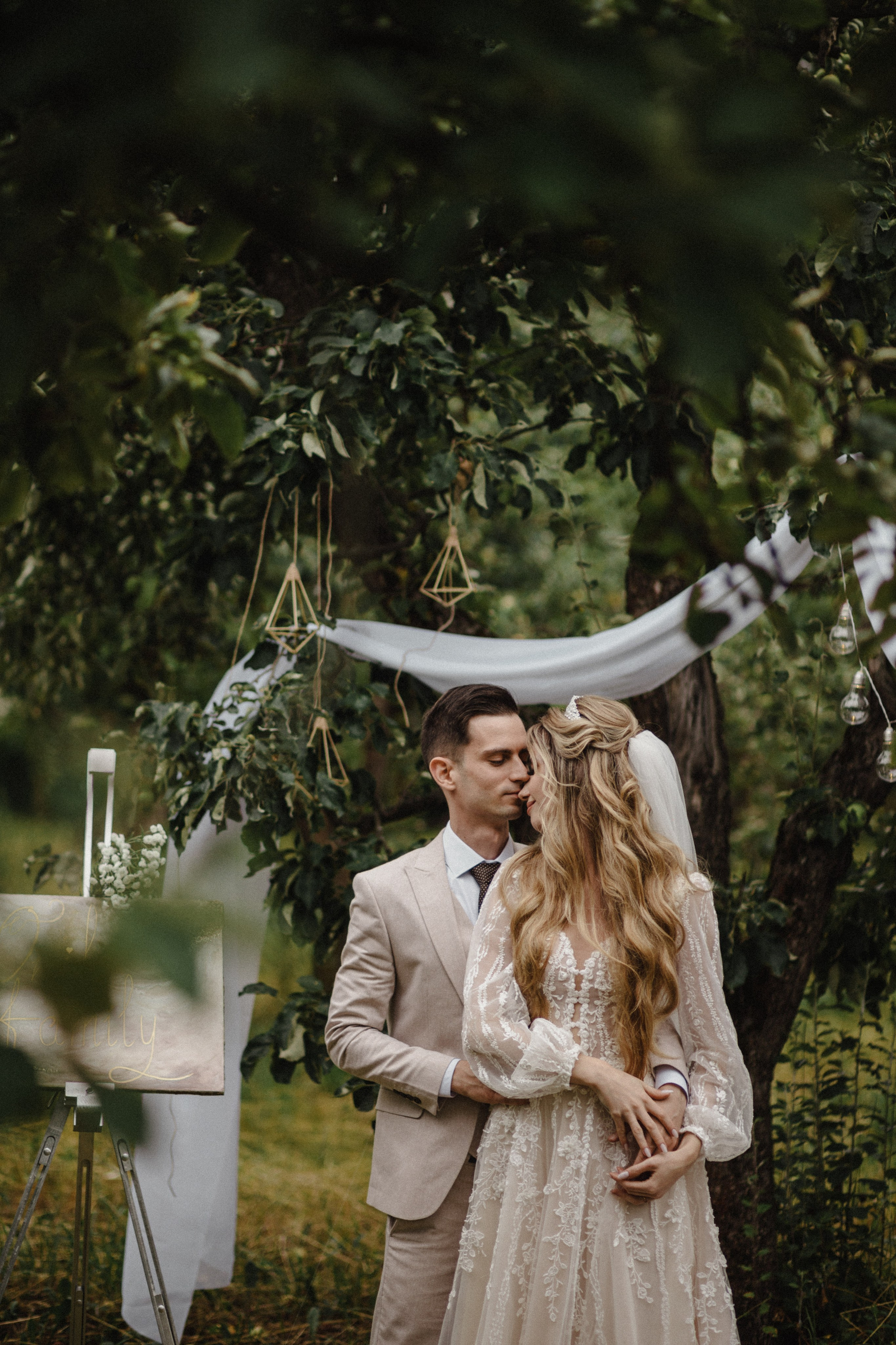 Elegant bride in minimalist dress and groom in classic suit during wedding ceremony