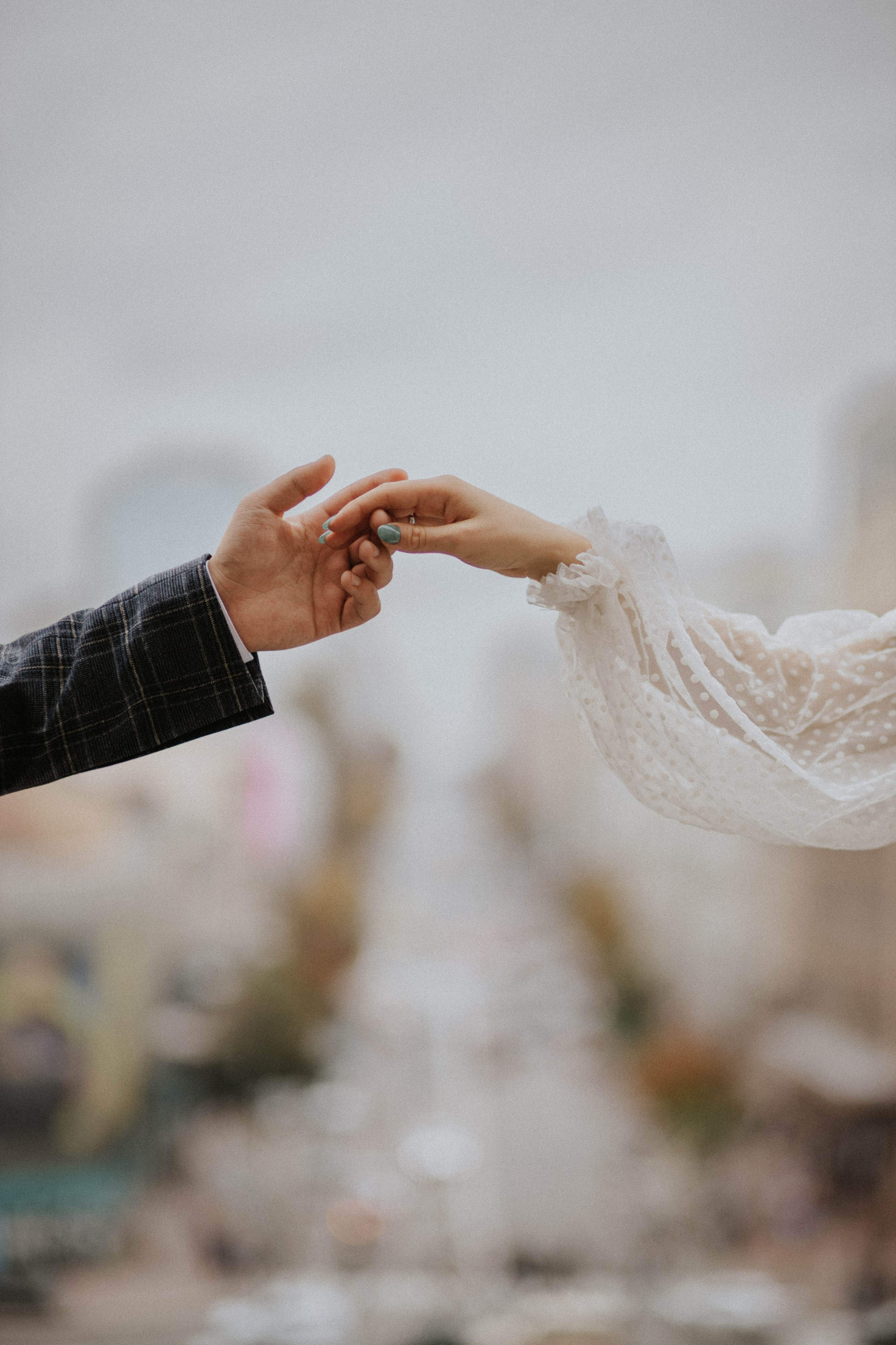 “Un primo piano delle mani degli sposi che si stringono dolcemente, a simboleggiare il loro amore e il loro impegno. Lo sfondo morbido mette in risalto il loro legame, rendendo questo momento perfetto per un matrimonio romantico in Toscana”.