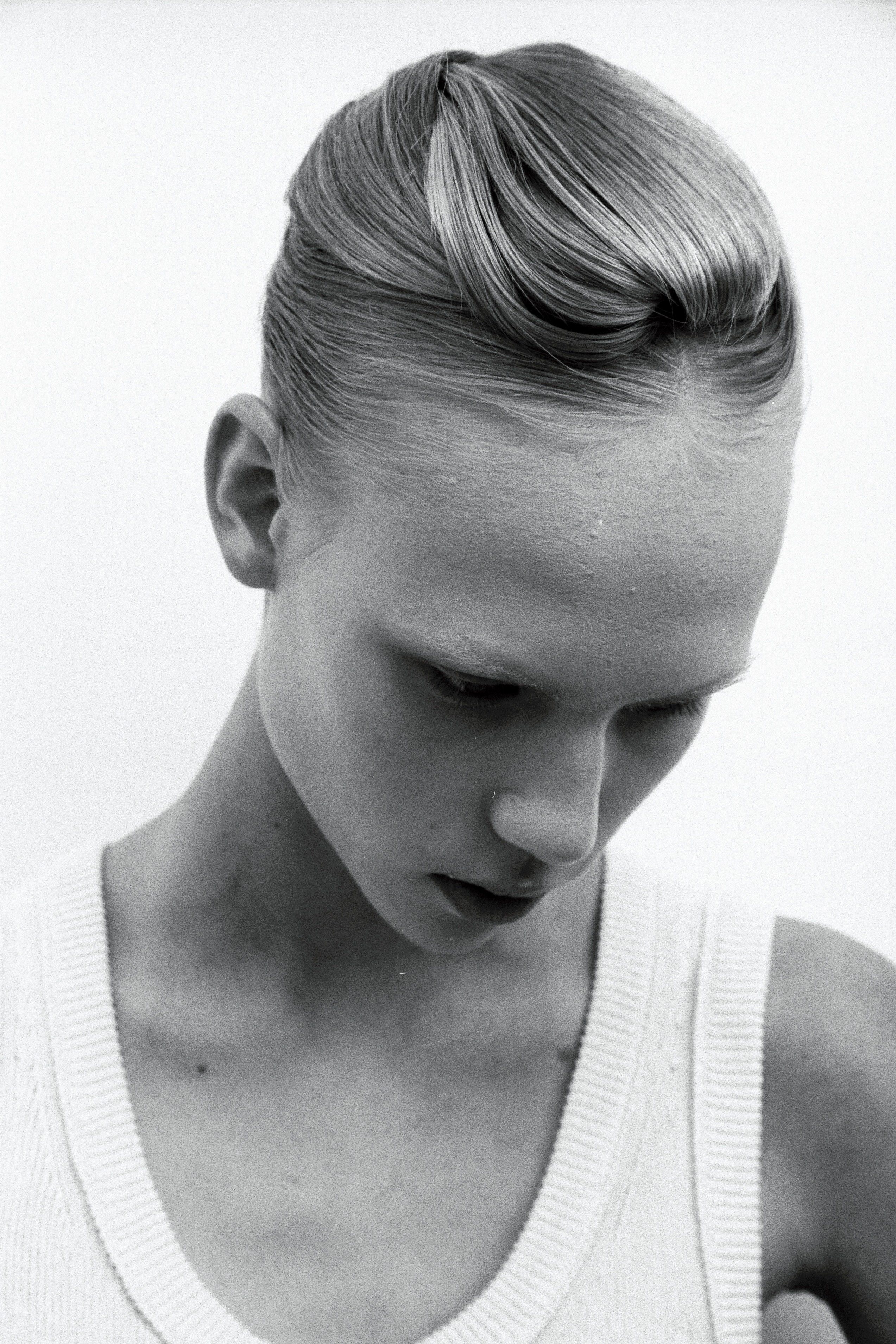 Styled fashion editorial portrait using vintage 35mm film stock, studio setting in Tallinn, Estonia