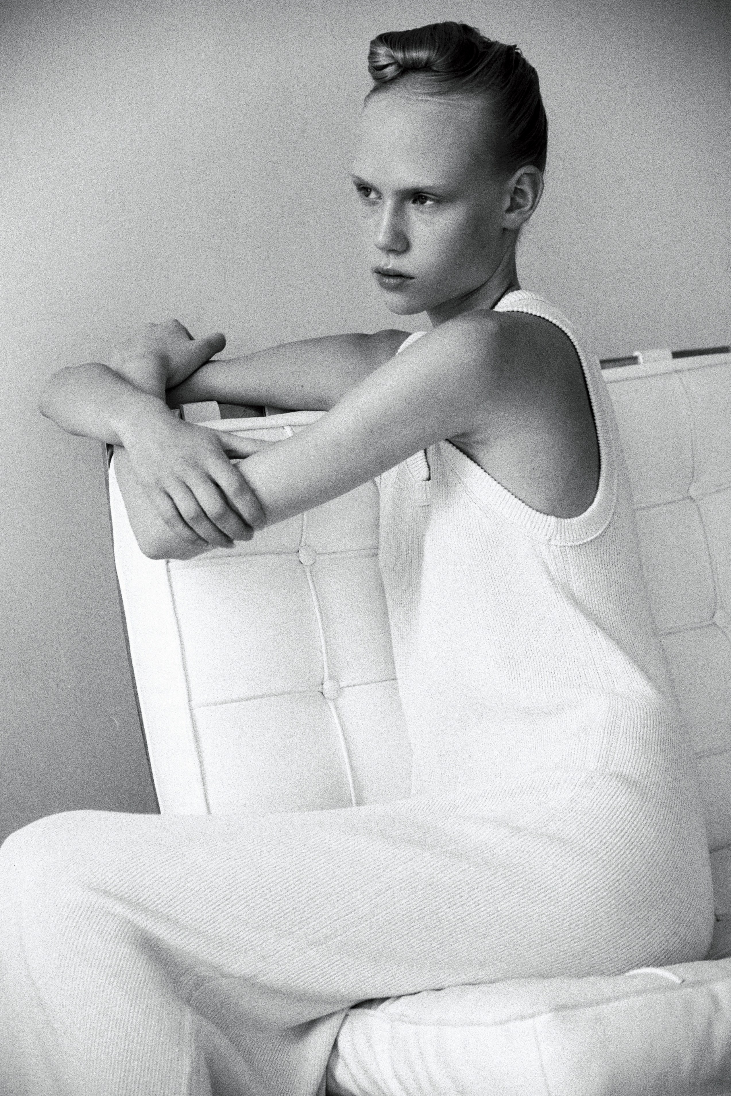 Creative black and white film portrait in a Tallinn studio, captured on 35mm analog film, stylish.