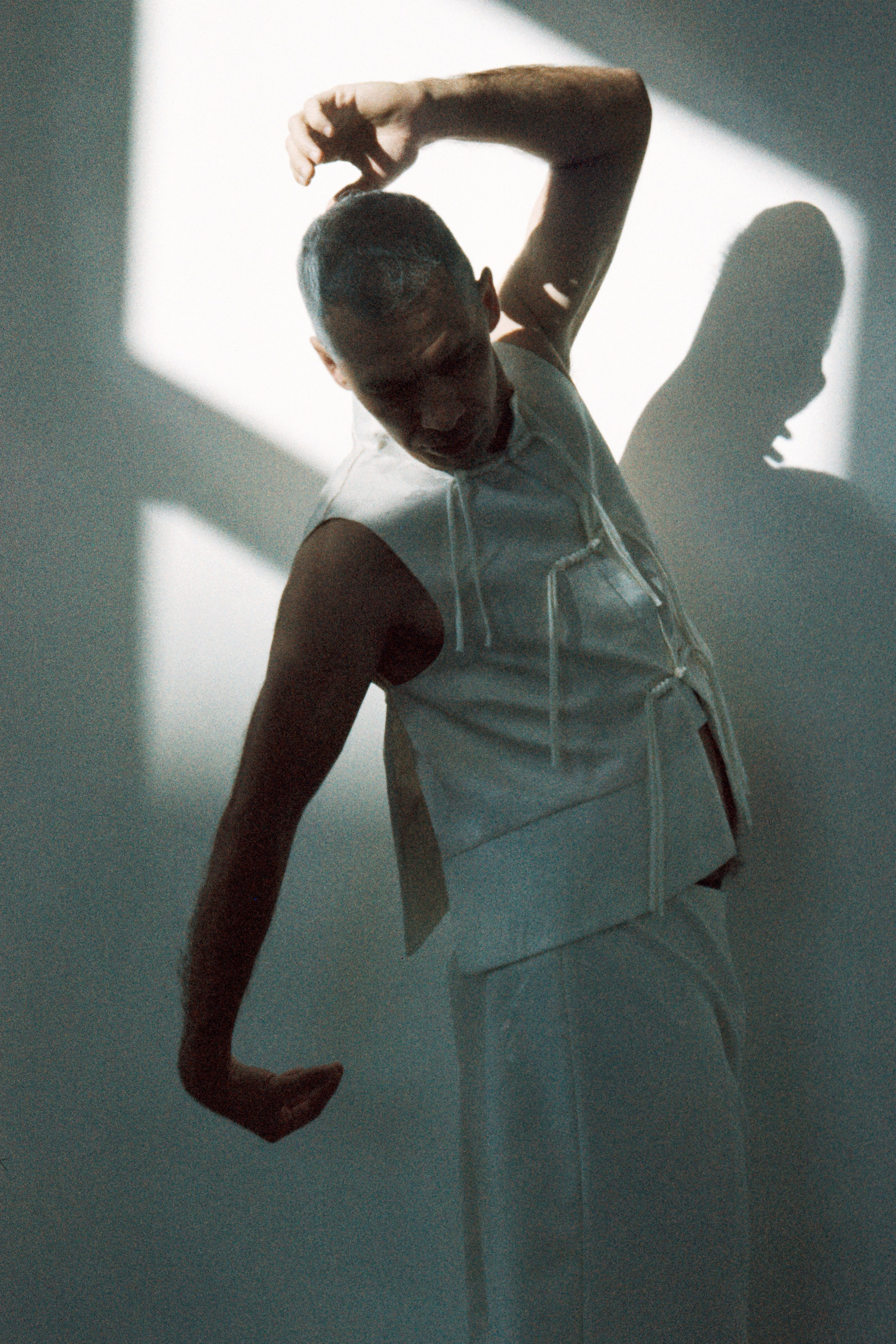 Classic 35mm B&W film portrait of a man, refined and minimalist studio photography by Sasha Khokh, movement, dance