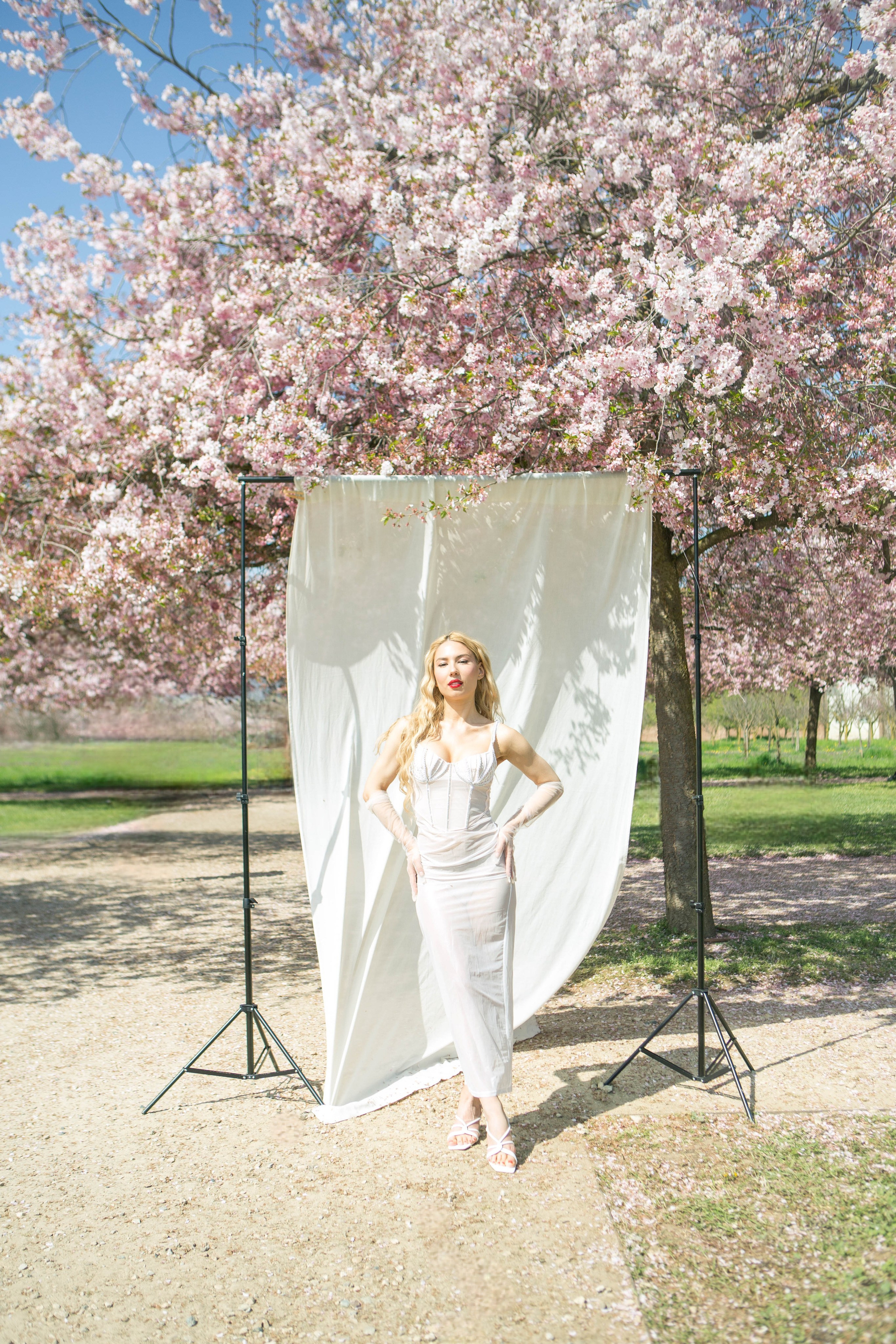 Bridal portrait on a studio background in blooming spring garden in Italy