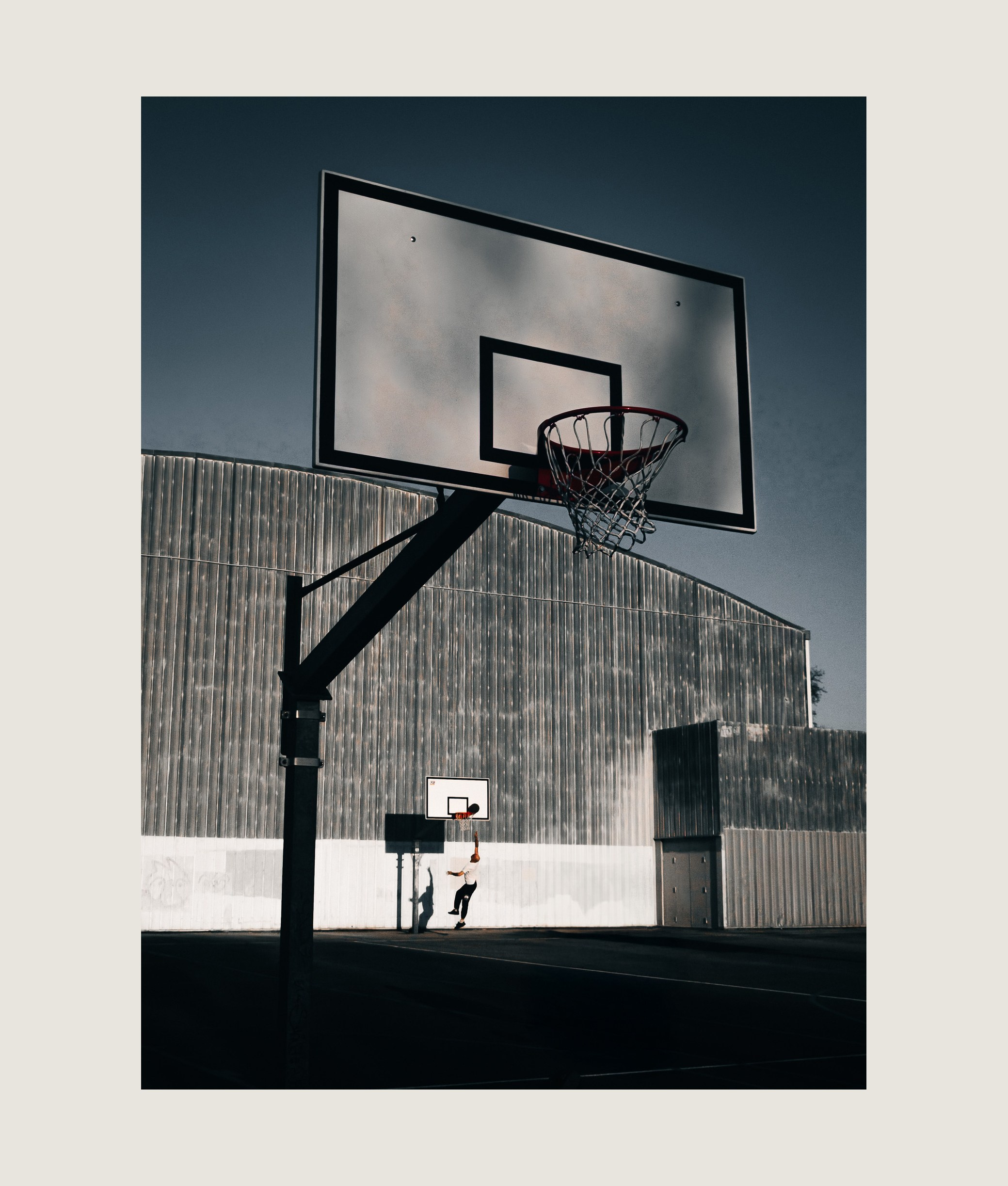 Athlete in motion on empty city basketball court