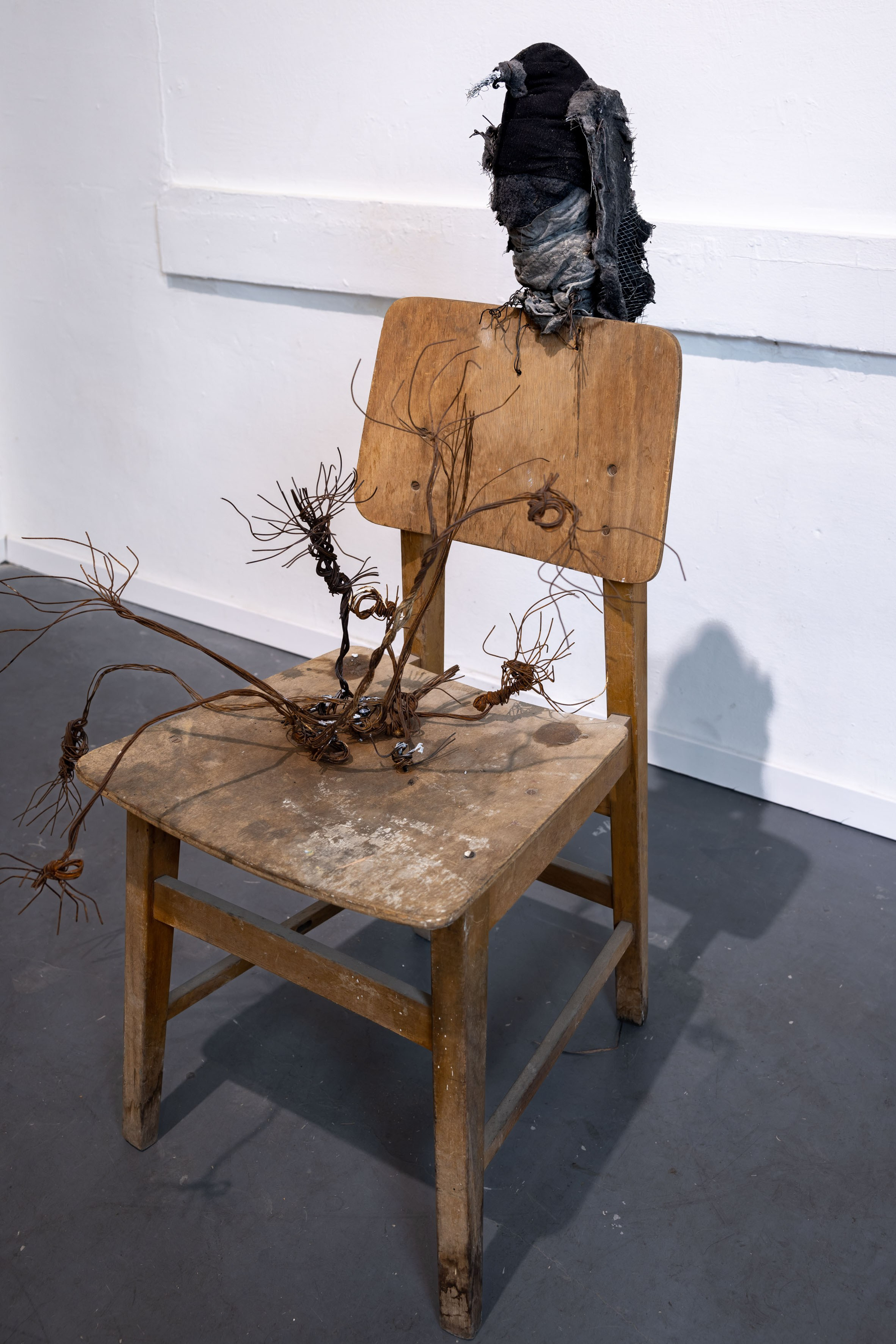 Bird and rusted flowers on chair, 2024