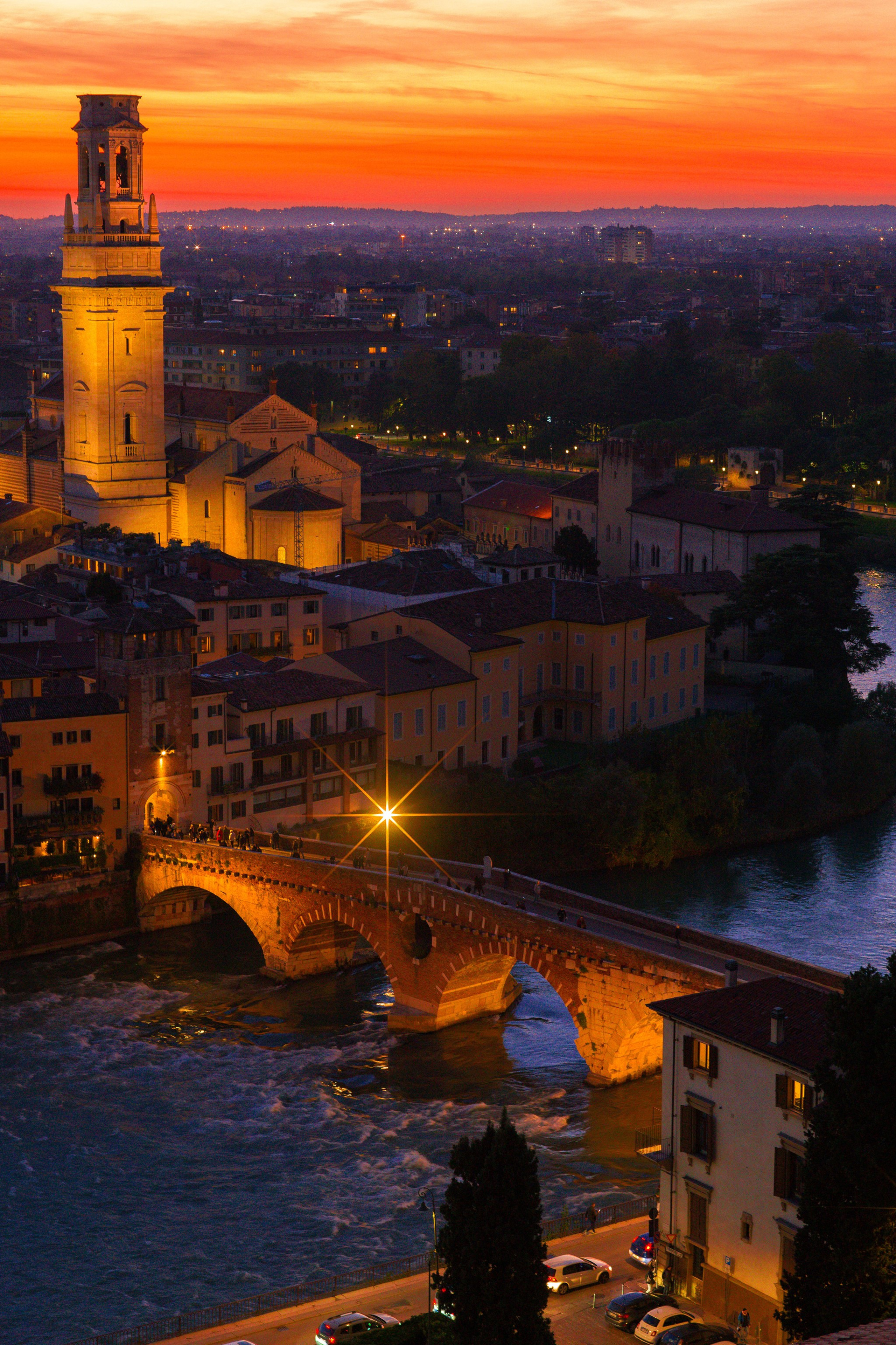 Bride and groom walking hand in hand through Verona’s ancient streets.