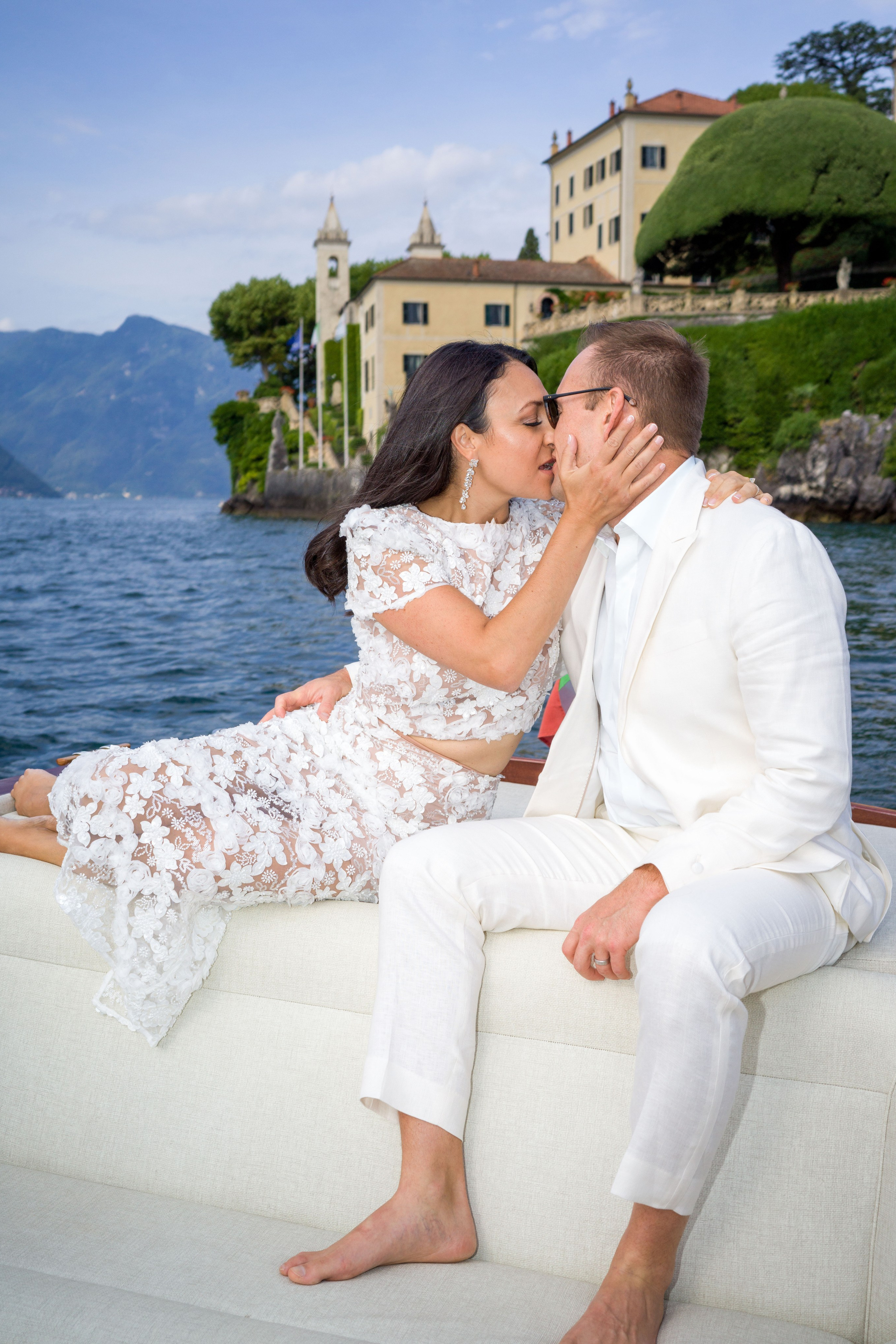 Couple embracing after proposal at Lake Como's famous villa.