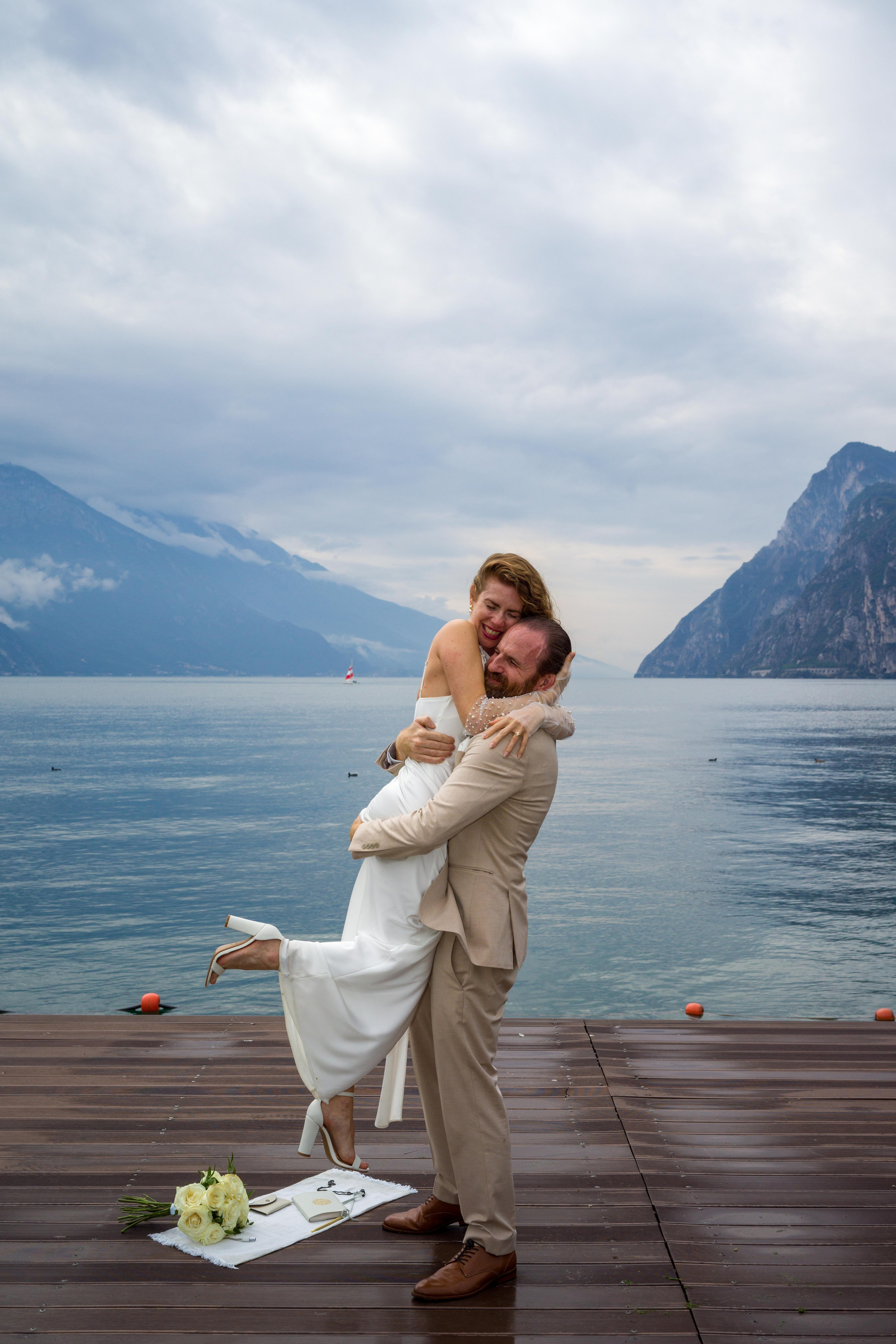 Couple enjoying elopement photo session at Lake Garda. Riva del Garda