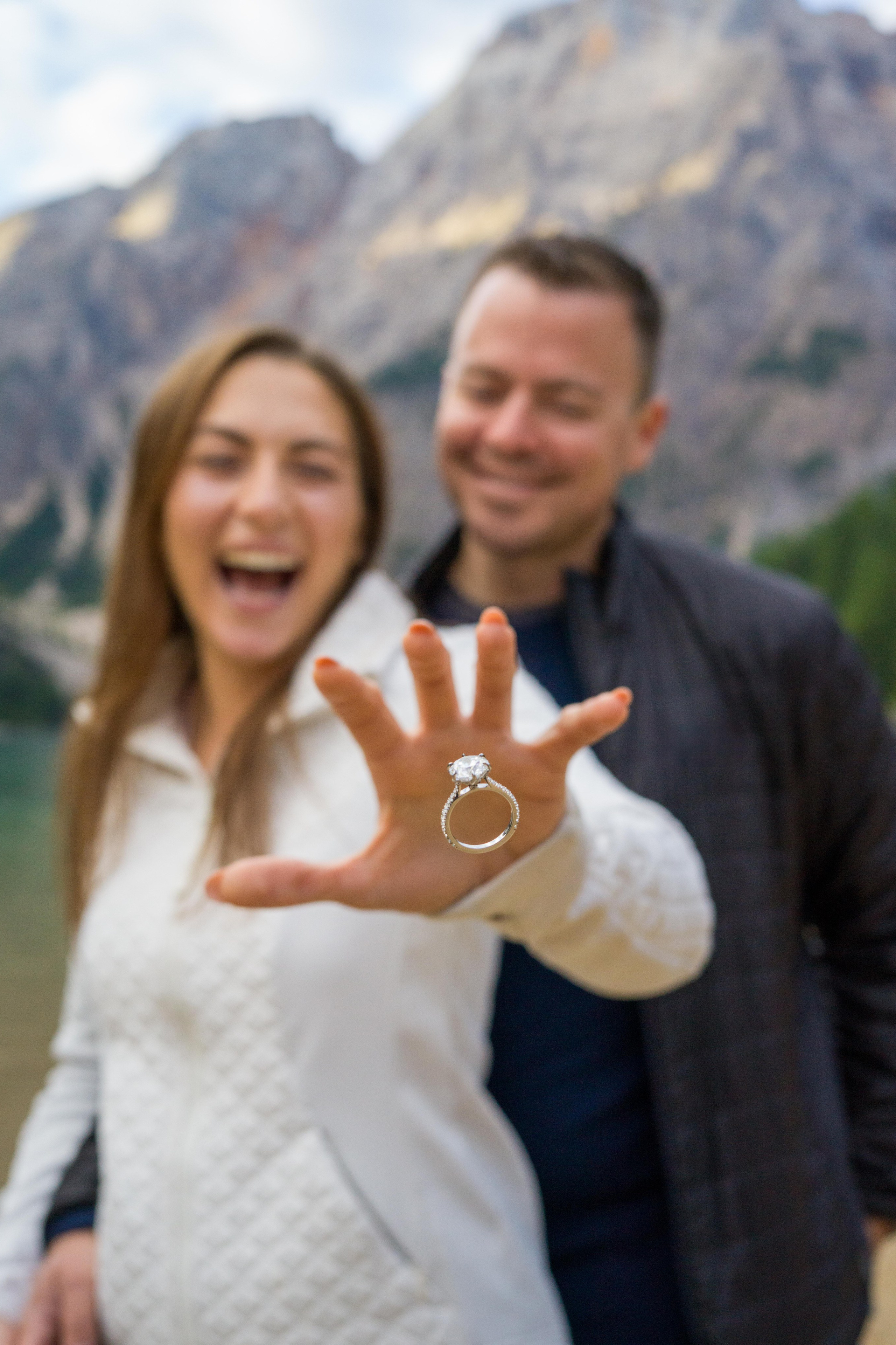 Couple celebrating engagement in mountains. Lake Braies